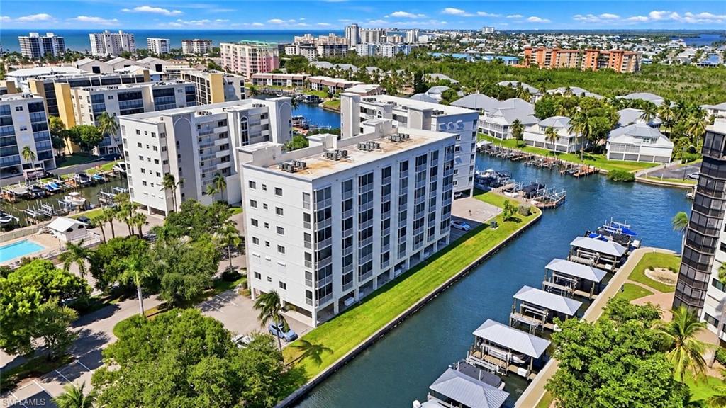 CORNER PENTHOUSE- PANORAMIC BAY/CANAL VIEWS- MAJOR 2024 RENOVATION. Enjoy the best of waterfront living in this beautifully remodeled, turnkey 2-bedroom, 2-bath corner Penthouse at Casa Marina on the desirable south end of Fort Myers Beach. Offering approximately 1,244 square feet, this furnished residence showcases sweeping intersecting canal views and stylish coastal finishes throughout. The open-concept design features luxury vinyl tile flooring, upgraded trim, and a stunning kitchen with shaker cabinetry, quartz countertops, stainless steel appliances, and breakfast bar seating. Both bathrooms have been tastefully renovated, and the spacious primary en-suite with a walk-in closet and direct access to the full-length screened and tiled lanai. Enjoy tranquil water views, plantation shutters, electric hurricane shutters, an enclosed laundry area, and convenient under-building parking. **Dock #55 is available for separate purchase**, offering an exceptional opportunity for boating enthusiasts. Community amenities include a swimming pool, fishing pier, beach access with shaded seating, and Bay Beach Commons recreational facilities featuring tennis, pickleball, walking trails, shuffleboard, and putting and chipping greens. Pet-friendly community with a 14-day minimum rental policy offers flexibility for personal use and investment potential. Ideally suited as a full-time residence, seasonal retreat, or vacation rental, this Casa Marina penthouse delivers the ultimate Southwest Florida coastal lifestyle.