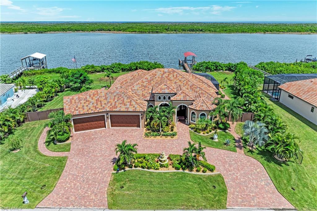 EXCEPTIONAL LUXURIOUS WATERFRONT LIVING WITH GULF ACCESS! 
Welcome to 16488 Leggett Circle, Port Charlotte, where the Southwest Florida boating lifestyle meets comfort, privacy, and an impressive list of upgrades. This beautifully appointed 3-bedroom, 3-full-bath waterfront home offers Gulf access through one lock, along with your own private dock featuring a 10,000-lb boat lift, Jet Ski accommodation, electric and water service—making it easy to enjoy days on the water right from your backyard.

Step outside and discover your own private Florida retreat. Relax in the concrete saltwater swimming pool and spa, entertain family and friends from the outdoor kitchen, or simply enjoy your morning coffee overlooking the peaceful waterfront. A 6-foot privacy fence adds seclusion, while an outdoor mosquito misting system helps make evenings by the pool and water even more enjoyable.

Inside, the home continues to impress with impact-resistant windows and doors, plantation shutters, a fireplace, gas range, tankless water heater, whole-house reverse-osmosis system, security system, and additional aluminum storm panels for the sliding doors. A whole-house generator provides an additional level of preparedness and convenience.

The property also features a circular driveway and garage parking for up to four vehicles, offering exceptional space for cars, recreational equipment, and all the extras that come with the Florida lifestyle.

From boating and waterfront entertaining to relaxing poolside at the end of the day, this home was designed to enjoy everything Southwest Florida has to offer. Pour your morning coffee, step outside, take in the beautiful water view, and imagine calling 16488 Leggett Circle home.