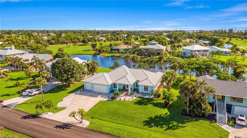 One or more photo(s) has been virtually staged, AI generated or rendered.  Welcome to your private Pine Island retreat, in the sought-after Alden Pines community. A boater's dream, less than a mile to the gulf.  This beautifully maintained 3-bedroom + den, 3-bath residence offers 2,619 square feet of thoughtfully designed living space on an oversized 0.34-acre lakefront homesite. The open great room floor plan features soaring vaulted ceilings and expansive pocketing sliders that seamlessly blend indoor and outdoor living.  Just moments from the famous Boca Grande Pass and its unrivaled fishing waters is the Safe Harbor Pineland Marina, your ‘Gateway to the Islands.’ Store your boat close to abundant fishing grounds.

The spacious owner’s suite is a true sanctuary with dual walk-in closets, direct lanai access, and a renovated luxury spa-inspired bath. A split-bedroom layout provides privacy for guests, while the den offers the perfect space for a home office or flex room.

Step outside to your screened lanai with a heated pool overlooking tranquil lake views and spectacular Florida sunsets. Mature tropical landscaping and fruit trees create a peaceful island setting ideal for entertaining or relaxing. Pick your own fresh mango, limes & avocado!

Additional highlights include a floor to ceiling stone fire-place, spacious 3-car garage, new metal roof, hurricane shades, laundry room, ample storage, and a beautifully appointed kitchen with breakfast bar and quality appliances. Located less than a mile from Gulf waters and just minutes from the restaurants, marinas, fishing, boating, and live entertainment of Matlacha and Pine Island, this home offers the perfect balance of quiet island living and outdoor adventure.

Whether you’re looking for a full-time residence, seasonal getaway, AirBNB, or investment opportunity, this exceptional property delivers the best of Southwest Florida’s relaxed waterfront lifestyle.
