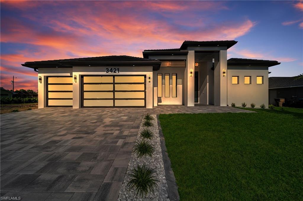 Brand-New Construction | Luxury Outdoor Living | Near the Seven Islands Development
Enjoy the Florida lifestyle in this beautiful new-construction home, ideally located just a one-minute walk from Joe Stonis Park and only a few minutes from the Burnt Store Boat Ramp. Another major highlight of this location is its proximity to Seven Islands, the planned Gulf Gateway Resort & Marina Village, an exciting waterfront development in Cape Coral that is designed to bring a resort, marina, restaurants, shopping, and public recreational spaces to the area. With its mix of waterfront amenities and entertainment, this planned destination adds another point of interest for buyers looking to be close to the area's future growth. Offering 2,606 square feet under air, this home features 4 bedrooms, 3 full bathrooms, a pool-access half bath, and a spacious 3-car garage. Impact-resistant windows, doors, and garage doors provide added peace of mind throughout the home. The kitchen is a standout feature, with top-of-the-line Samsung appliances, built-in lighting, and a beautiful waterfall-edge island with built-in pop-up outlets for a sleek, modern look. A spacious laundry room with washer and dryer adds convenience to everyday living. The primary suite features walk-in closets and a large bathroom with dual showers and a separate tub. Direct access from the primary bedroom to the lanai makes it easy to enjoy the outdoor living space. Out back, you'll find a screened-in pool area designed for relaxing and entertaining. The 30' x 16' heated pool features a sunbathing island, complemented by a 12' x 7' heated spa. The outdoor kitchen includes durable aluminum cabinetry made with Starboard materials, a built-in grill, and a wine cooler. A convenient half bath with direct pool access keeps the outdoor area comfortable for guests, while podocarpus trees along the rear of the property provide added privacy. Between the modern finishes, impressive outdoor amenities, proximity to local parks and boating, and the planned Seven Islands waterfront destination nearby, this home offers a great opportunity to enjoy Southwest Florida living in an area attracting continued interest and development.