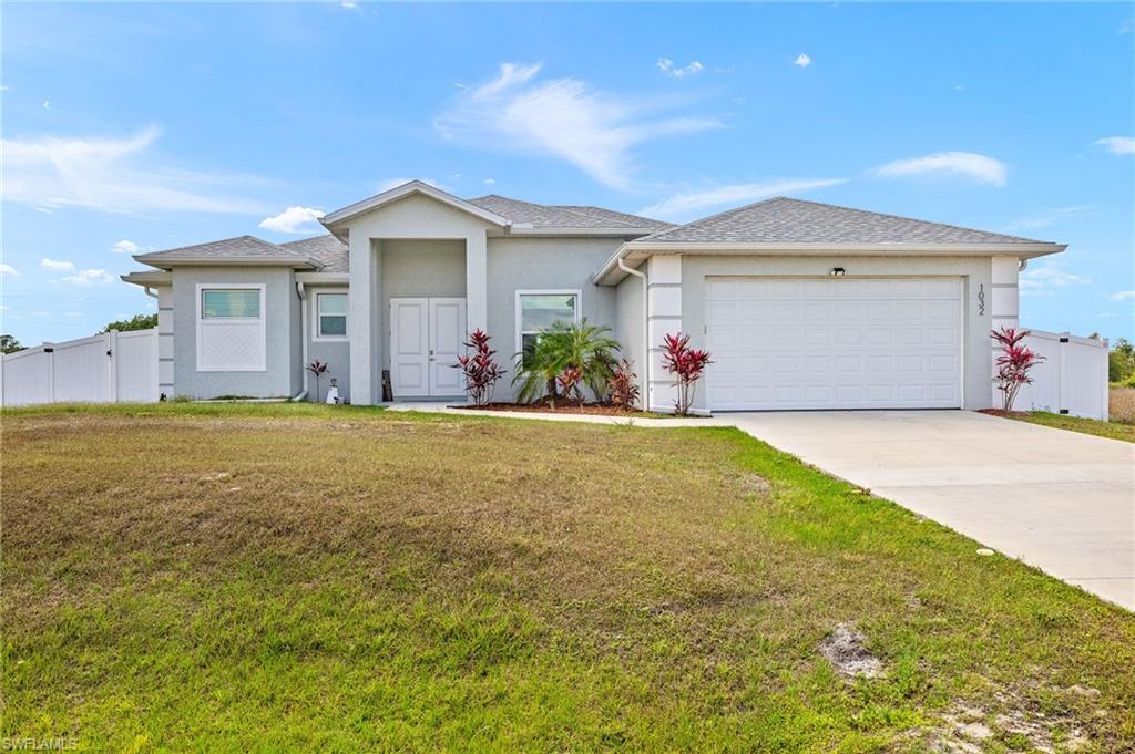 This beautifully designed 3-bedroom, 3-bath home with a den offers an open-concept layout that’s perfect for everyday living and entertaining. Completed in 2023, it features a spacious kitchen with a large island and a generous walk-in pantry, while each bedroom boasts abundant closet space for all your storage needs. The split-bedroom floor plan includes a primary suite with a luxurious bath, and one of the guest bedrooms has its own ensuite with access to the backyard—making it ideal as a future pool bath. The real highlight is the expansive screened-in covered lanai, complete with a built-in outdoor kitchen featuring a grill and refrigerator, overlooking a fully fenced backyard with ample space for kids, pets, or even a future pool.