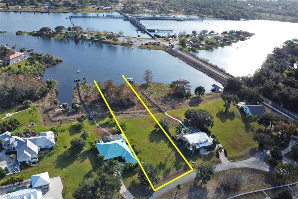 Riverfront opportunity in the deeded community of Riverwind Cove, offering expansive views of the Caloosahatchee River. This cleared homesite spans nearly 1.1 acres with over 100 feet of direct river frontage, providing an ideal setting to build a custom estate home. Riverwind Cove is an upscale community featuring underground utilities, street lighting, and an equestrian center, blending privacy with thoughtful planning. Conveniently located near the Franklin Locks boat ramps and nearby state parks offering camping and hiking, with Fort Myers just 15 minutes away. A rare chance to capture Old Florida charm at an exceptional value. All serious offers will be considered.