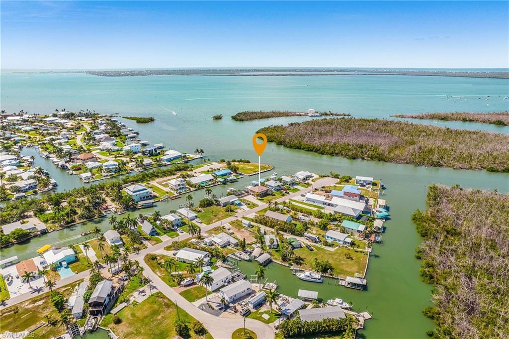 Rare opportunity to own a DIRECT GULF ACCESS waterfront pool home situated on TWO oversized lots with an impressive 120 feet of waterfront in the heart of beautiful Pine Island. Offering quick, unrestricted boating access with no bridges, this exceptional property is just a short ride to Sanibel, Captiva, Cayo Costa, and some of Southwest Florida's most renowned fishing waters. Whether you're heading offshore for world-class fishing, cruising to waterfront restaurants, or exploring secluded barrier islands, this location is truly second to none.

Designed for both comfort and peace of mind, the home features a durable metal roof, impact-resistant windows, and a brand-new Generac whole-house generator fueled by "three" 300-gallon propane tanks, ensuring you're well prepared year-round. A spacious waterfront viewing platform provides the perfect place to relax, entertain, or simply soak in the expansive water views and unforgettable Florida sunsets.

The sparkling pool overlooks the canal, creating an ideal setting for outdoor living, while the generous waterfront offers ample space for your boating lifestyle. Surrounded by the natural beauty of Pine Island, you'll enjoy a relaxed Old Florida atmosphere with nearby marinas, waterfront restaurants, kayaking, nature preserves, and endless opportunities for boating and fishing. Properties offering two lots, 120 feet of waterfront, direct Gulf access, and premium upgrades like these are exceptionally rare.
