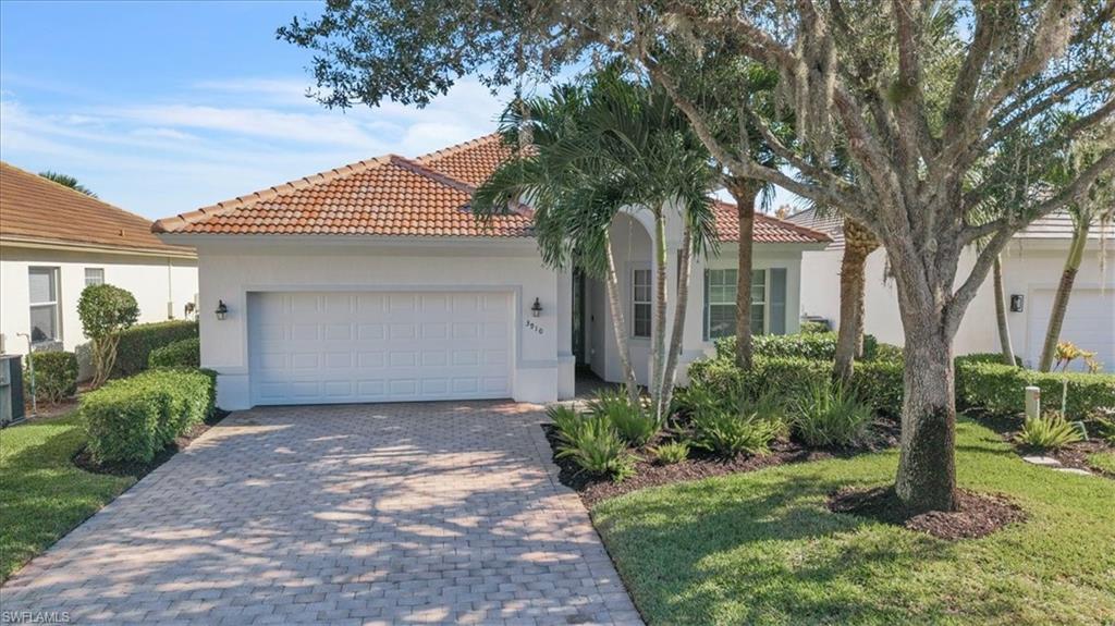 This immaculate and completely renovated 2 bedroom + den, 2 bathroom home boasts 1835 sq. ft. of living space and a 2 car garage with a stunning lake view. This home is a must-see and will not last long on the market. The owners have meticulously cared for their home, and with all of the upgrades, it is essentially move-in ready. Some of the outstanding features of this home include a NEW ROOF installed in 2023, a NEW AC unit also installed in 2023, custom built-ins in the great room and den, a bar area with a wine cooler, a built-in fireplace in the family room, tile flooring throughout, a custom closet organizer in the primary bedroom, tray ceilings in the dining area and primary bedroom, upgraded countertops in the kitchen and bathrooms, white custom cabinetry in the kitchen with an attractive backsplash and under cabinet lighting, newer stainless steel appliances, plantation shutters, and elegant window coverings throughout the home. The front entry door features an elegant glass insert, and there are upgraded lighting and fan fixtures throughout. The outdoor area of this home is truly an oasis of comfort, with features that enhance the overall living experience. The slider pocket doors open up to an expansive and private lanai, making the space even larger. Other outdoor features include a heated saltwater pool and spa, picture windows screens for an enhanced view of the adjacent lake, electric storm shutters for added safety and peace of mind, a custom outdoor kitchen with an additional wine cooler, and a spacious undercover area for entertaining friends and family. All of this is set in a private and serene setting with an eastern rear exposure. Located in the gated Verandah community, residents will have access to 2 championship golf courses designed by Bob Cupp and Jack Nicklaus, a full clubhouse with dining options including some outdoor dining during the seasonal months, an active social calendar, a complete tennis facility and pickleball complex, a state-of-the-art fitness facility, kayaking/canoeing, 9 miles of bike and jogging paths, a dog park, playground, and bocce courts. Don't miss the opportunity to see this turnkey, move-in ready home before it's gone. Secure your place in paradise now!