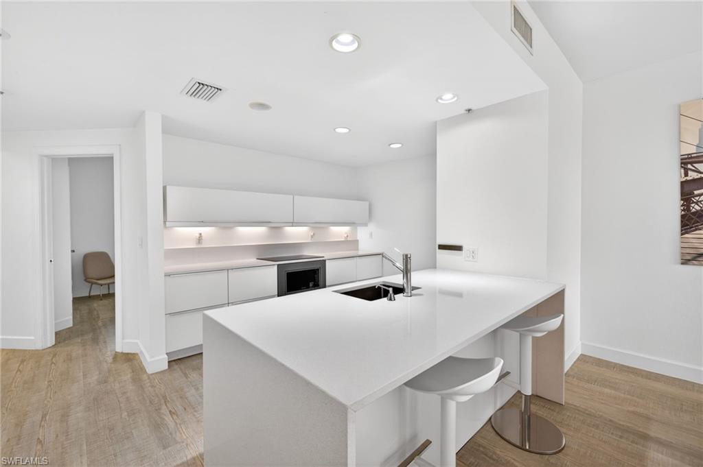 Experience New York chic in the Florida sun in this turnkey furnished beautifully updated high-rise condominium. Designed with a refined modern aesthetic, the residence features a fully renovated kitchen and baths design by Dino Raccanello, renowned Australian/Italian designer architect, blending sleek lines with sophisticated finishes. This spacious three bedroom, two-bath home offers 1,786 square feet of thoughtfully designed living space, enhanced by continuous laminate flooring throughout and an extended. Enjoy tranquil views overlooking the resort-style pool, spa, and marina, creating a serene backdrop for both everyday living and entertaining. Recent upgrades, including a newer air conditioning system and hot water heater, provide added comfort and peace of mind. North Star is set within 12 acres of gated waterfront grounds and offers an exceptional 15,000 square feet of resort-caliber amenities. Residents enjoy a sun-drenched southern-facing pool and spa, a state-of-the-art fitness and aerobics center, steam rooms, locker facilities, and inviting social spaces including billiards and card rooms, a business center, and a library. Outdoor enthusiasts will appreciate three pickleball courts and a tennis court. Boating enthusiasts can lease a slip in the marina, while a scenic waterfront promenade leads to four popular dining destinations. During season, take advantage of the complimentary trolley service to downtown Fort Myers’ vibrant River District, home to an array of acclaimed restaurants, boutique shopping, art galleries, and theaters.This residence offers a rare combination of modern design, resort-style amenities, and an unbeatable waterfront lifestyle. Reach out today to make this unique condo your own.