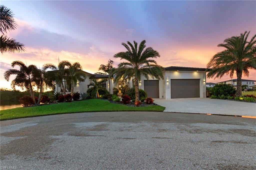 The pinnacle of waterfront luxury awaits in this newer-construction, move-in ready 4-bedroom, 3.5-bathroom custom estate. Perfectly positioned at the end of a quiet cul-de-sac just off prestigious Surfside Boulevard, this architectural masterpiece sits on an oversized, direct Gulf-access lot. Built for a refined, turn-key lifestyle, the home showcases a sprawling open floor plan beneath soaring 12-foot custom ceilings with high-end upgrades at every turn. The Owner’s Sanctuary: The primary suite serves as a private oasis, pairing tranquil water views with dual custom walk-in closets. The spa-like ensuite features a deep soaking tub and a massive, meticulously tiled walk-in shower. The Culinary Experience: Epicureans will marvel at the gourmet chef's kitchen. It comes fully equipped with premium Wolf cooking appliances, a spectacular integrated island, and a hidden pantry room—ingeniously designed with a second refrigerator and a direct-from-garage grocery pass-through door. The Indoor-Outdoor Oasis: Designed for seamless entertaining, innovative zero-corner pocketing sliders disappear entirely, blending the interior with a magnificent outdoor retreat. This space features a full outdoor kitchen, automated saltwater pool and spa, and elegant shell stone flooring—all framed by unforgettable, unobstructed sunset views. A Boater & Car Enthusiast's Paradise: Boaters will appreciate the private dock and a massive, 245-foot wrap-around seawall ready to accommodate multiple large vessels. For the automotive collector, the 27’+ deep, temperature-controlled 3-car garage features soaring ceilings perfect for a car lift, epoxy floors, insulated 9-foot doors, and dual EV power outlets. Advanced Infrastructure: No detail was overlooked in the structural integrity and efficiency of the home. Premium features include impact-resistant glass, spray foam insulation, a flat tile roof, motorized window blinds, a dedicated storage room, and a buried 500-gallon LP tank. Best of all, all assessments are in and fully paid. Privacy is key with nothing but water and protected preserves from all exterior living areas on this rare intersecting spreader view location. Don't miss your chance to live the ultimate coastal dream in an elegant, meticulously crafted home that masterfully balances high refinement with everyday comfort. Your exceptional lifestyle starts here.