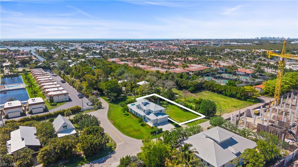 A rare cleared homesite just east of Royal Harbor and behind the Naples Bay Club, offering 70' of frontage and 160' of depth (0.26 acres) with no HOA. The west-facing rear exposure sets up beautiful evening light and sunsets for whatever you design.
Location is what sets this lot apart. You're steps from Naples Bay Club, offering memberships that include a resort-style pool with lazy river, tennis, fitness and spa facilities, and on-site dining at BlueWater Bar & Grill and Indulge. Just across the street, a brand new JW Marriott is under construction, bringing a restaurant and lounge to the corridor. From here it's about a mile to Fifth Avenue South and Third Street South for shopping, dining and galleries, with Naples Bay, Tin City, and the Bayshore Arts District close by, plus easy access to the Gulf's white sand beaches. The street is in the middle of an exciting transformation, with new construction steadily reshaping the block.