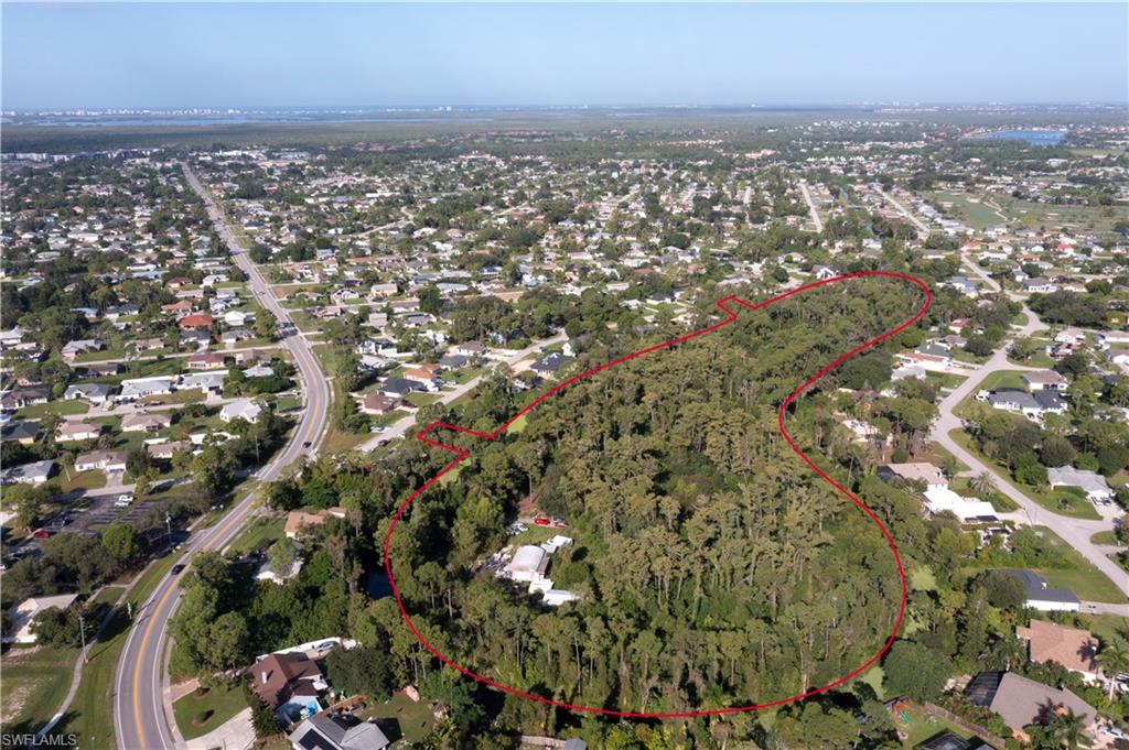 Discover a rare opportunity to own nearly 15 acres of prime land in Fort Myers, perfectly situated within the city yet offering a private, natural retreat. This offering includes contiguous three vacant lots being sold together, providing two access points for convenience and flexibility. The site is rich with Florida’s native flora, including mature trees and the iconic Dahoon Holly, and serves as a sanctuary for local wildlife. A recent survey shows only 0.66 of the property is wetlands and an environmental survey delineates minimal mitigation for full use of the 15 acres. While remnants of previous structures, including an in-ground pool, spa, guest bungalow, carport, and gazebo, remain, the land is a blank canvas for new construction or creative development. This “inland island” setting offers a unique blend of seclusion and accessibility, ideal for buyers looking to craft a private estate with abundant space. Don’t miss the chance to secure this extraordinary parcel, combining location, history, and natural beauty in one exceptional property. New FEMA flood determination according to letter dated September 2, 2026 designates the property AH Without Base Flood Elevation.