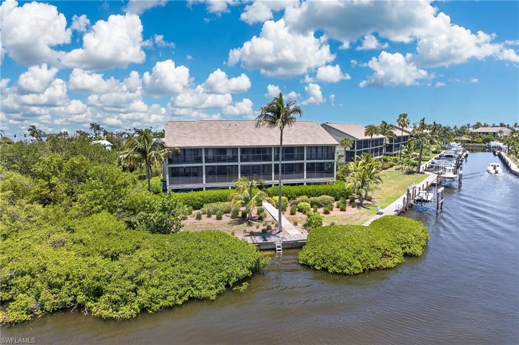 Experience SPECTACULAR WATER VIEWS from this beautifully positioned corner residence in the highly desirable Bocilla Island Club. This is widely considered the premier building in the community, offering panoramic water vistas from both levels and an abundance of natural light through additional side windows unique to this END UNIT.

For boaters and anglers, this property is truly a rare find. Included is a PRIVATE BOAT SLIP with a 10,000-pound lift, accommodating boats up to 24 feet, providing quick access to Charlotte Harbor, Boca Grande Pass, Cayo Costa, North Captiva, world-class tarpon fishing, backwater flats, and some of Southwest Florida’s most pristine beaches. Ask almost any local fishing charter captain and they’ll tell you these are among the finest fishing grounds in all of Lee County. Anglers can achieve the coveted Grand Slam of fishing right in the vicinity. Abundant Snook, Redfish, Sea trout, and Tarpon are just a few of many prized local catches

Relax on your screened lanai while watching dolphins, manatees, and boats cruise by, all with peaceful waterfront views as your backdrop. IMPACT WINDOWS AND DOORS provide peace of mind, while the floor plan offers a first-floor living area with a convenient half bath. Upstairs features a generous primary suite with breathtaking views, a walk-in closet, updated bath, private waterfront lanai, plus a guest bedroom with its own private bath. Additionally there is a convenient full sized laundry room.

Additional highlights include a private storage room adjacent to the covered parking space. The oversized assigned under building parking space has plenty of room for both your vehicle and golf cart. Seasonal rentals are permitted, making this an outstanding investment opportunity with an established rental history.

Bocilla Island Club offers a true resort lifestyle with two heated pools, tennis and pickleball courts, shuffleboard, beautifully landscaped grounds, scenic waterfront walking paths, a private fishing pier on Charlotte Harbor, and a kayak launch. Walk to nearby restaurants and Four Winds Marina, a full-service marina just minutes away. Flood insurance is included through the HOA.

Whether you’re searching for the ultimate winter escape, year-round waterfront residence, or income-producing vacation property, this exceptional home combines breathtaking water views, unmatched fishing and boating, and the laid-back island lifestyle that makes Bokeelia so special.