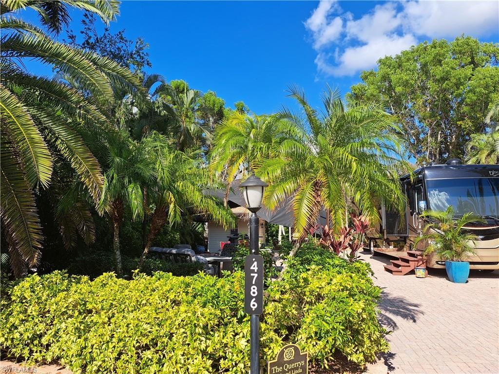 Located in the Pelican Lake Motorcoach Resort, this off-lake site lies between Marco Island and Naples, Florida. It boasts a completed paver pad and patio, encircled by beautiful landscaping that ensures privacy. As you position your motorcoach on the site, the windshield will be south facing. Behind the site is a spacious area leading to the resort's fence, ideal for leashed pets. The site covers an area of roughly 5,227 square feet. Golf cart included!
This 10x10 coach house is fully finished inside, featuring a shower, toilet, sink, and washer/dryer. It also includes overhead storage with decorative baskets. There's space for a futon or any other furniture of your choice. The exterior boasts a wrap-around awning.