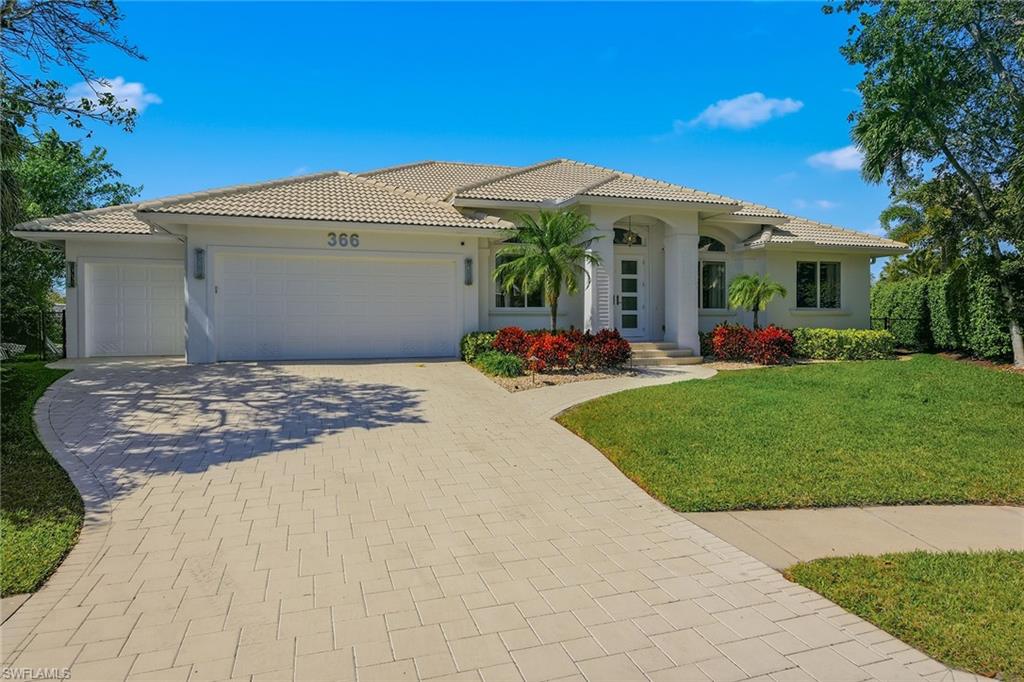 Exceptional indoor-outdoor waterfront living awaits in Marco Island's popular River neighborhood, where this immaculate tip-lot residence offers privacy, western water views and sunsets, an expansive lanai, and an excellent dock and lift setup for boaters. Enhancing this waterfront offering, a boat and two jet skis are included in the sale. Enjoy direct Gulf boating access with no bridges and reach the river in less than five minutes to explore the Gulf and nearby islands. From the moment you enter, the view through the great room to the pool and water creates an unforgettable welcome. Updated wide-plank luxury vinyl flooring, lighting and ceiling fans complement impact windows and doors, custom window treatments and electric storm screens. This single-story home offers natural light, three bedrooms plus an office/den and nearly 2,100 square feet of living space, with an ideal open floor plan. Soaring 14-foot tray and volume ceilings, crown molding and solid interior doors add architectural distinction. The great room features a double tray ceiling, recessed lighting, an oversized ceiling fan and sliding glass doors opening to the lanai. The kitchen showcases solid cherry cabinetry with glass-front uppers, quartzite counters, a tile backsplash, stainless appliances, peninsula breakfast bar and walk-in pantry. A bay-windowed breakfast nook provides a casual setting, while the dining room features a tray ceiling, cascading glass chandelier and transom window. The primary suite offers lanai access, a tray ceiling, crown molding and large walk-in closet. Its bath includes dual vessel sinks, wood cabinetry, a soaking tub, skylight and frameless glass shower with floor-to-ceiling tile, mosaic accents and handheld showerhead. Two guest bedrooms, one with pool access, and a separate office/den provide space for visitors and working from home. An expansive covered lanai and heated saltwater pool and spa within a screened enclosure set the stage for sunset relaxation and waterside entertaining. Wi-Fi-enabled AquaLink controls provide pool and spa operation through an app. Thoughtfully designed indoor and outdoor spaces make waterfront living a delight. Two composite docks, a 20,000-pound boat lift and dual jet ski lift support a boating lifestyle. Completed permitting and approvals for a new dock of approximately 1,000 square feet offer an opportunity to enhance the waterfront. Beyond your private retreat, enjoy Marco Island's beaches, shelling, fishing, kayaking, paddleboarding, waterfront dining, boutiques, parks, tennis, pickleball, golf, art center and Marco Island Historical Museum. Named America's top island and fourth in the world in Tripadvisor's Travelers' Choice awards, Marco Island offers a coastal lifestyle with access to the Ten Thousand Islands and Everglades adventures. Executive airport nearby for access to your vacation home in paradise.