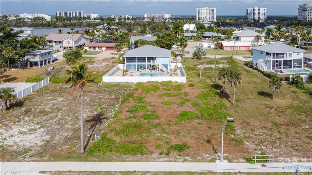 Located at 8033 Estero Blvd., Fort Myers Beach, FL 33931, this residence delivers coastal living with an Exceptional Gulf-Access Homesite, Weekly Rentals Permitted.  Located in the charming Laguna Shores community on Estero Boulevard, at the highly desirable south end of Fort Myers Beach, this premier parcel offers an unparalleled opportunity to build a custom island retreat or income-producing coastal residence.  Positioned directly across the boulevard from the white sugar-sand beaches of the Gulf of Mexico, the property includes deeded beach access just steps away—allowing you to enjoy breathtaking sunsets and the ultimate beach lifestyle every day. The lot is fully prepared with utilities in place, making it ready for construction.  Spanning nearly a quarter acre, there is ample space to design a luxury coastal home complete with a private pool and outdoor living areas. Weekly/short-term rentals are permitted, providing excellent flexibility for personal use, investment income, or future development.  This prime location places you near some of Fort Myers Beach’s most exciting destinations, including Santini Plaza, Publix, CVS, and the newly opened Jimmy Buffett’s Margaritaville Resort. Enjoy easy access to island dining, boutique shopping, live entertainment, boating, fishing, jet skiing, kayaking, and the high-speed Key West ferry. Golf, tennis, and boat rentals are also nearby.  Convenient on-and-off island access allows for quick drives to Naples, Bonita Springs, Estero, and Fort Myers, with RSW International Airport approximately 30 minutes away and Punta Gorda about 45 minutes.  Whether you’re envisioning a private island escape, a luxury vacation rental, or a long-term investment in one of Southwest Florida’s most sought-after coastal markets, this homesite delivers location, lifestyle, and income potential—all in one extraordinary offering.  Create your masterpiece and embrace the very best of beach living.
INFORMATION IS DEEMED RELIABLE BUT NOT GUARANTEED…TO BE VERIFIED BY THE BUYER AND/OR BUYER'S AGENT, INCLUDING UTILITIES.
