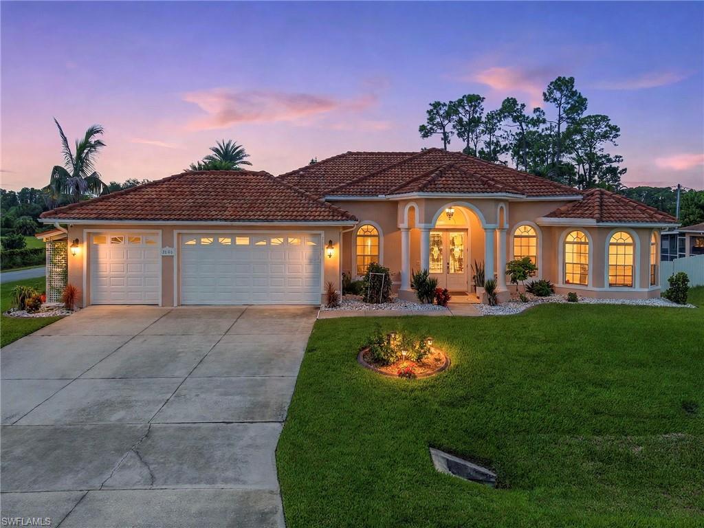 Welcome to this spacious **4-bedroom, 3-bathroom home with a 3-car garage**, ideally situated on a desirable **corner lot in Lehigh Acres**. This beautifully appointed residence features **tile flooring throughout, high ceilings, and a bright, open-concept floor plan** designed for comfortable everyday living and entertaining.

The spacious kitchen is the heart of the home, offering **granite countertops, abundant cabinetry, and an open layout** overlooking the main living areas. The primary suite provides a private retreat with **walk-in closets** and a generously sized bathroom featuring **dual sinks, a jetted soaking tub, and a separate walk-in shower**.

Step outside to the **screened lanai with an outdoor kitchen**, creating an excellent space for entertaining, grilling, or simply enjoying the Southwest Florida lifestyle year-round. Additional features include a **newer roof, reverse-osmosis system, water softener, and an oversized 3-car garage** offering plenty of room for vehicles and additional storage.

Located in **Lehigh Acres, just east of Fort Myers**, with convenient access to shopping, dining, parks, golf courses, and outdoor recreation. Enjoy nearby destinations such as Veterans Park, Harns Marsh Preserve, and other recreational areas, while remaining within driving distance of **Fort Myers, Southwest Florida International Airport, I-75, and the Gulf Coast**. ([Visit Florida][1])

**Spacious, well-equipped, and ready for its next owner—schedule your private showing today and discover everything this Lehigh Acres home has to offer!**