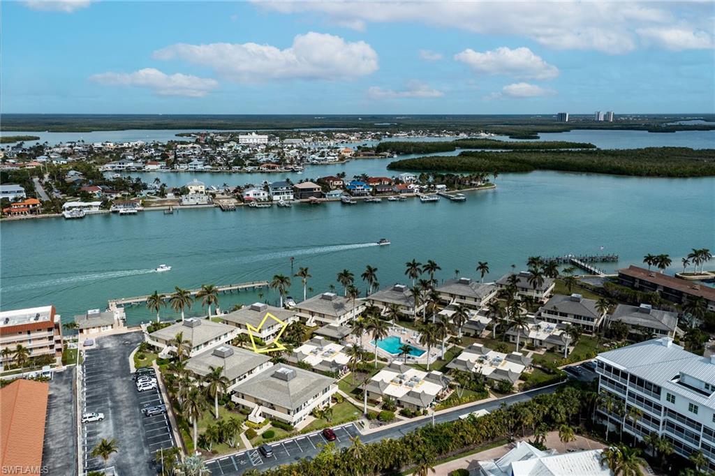 Ideally positioned within the waterfront community of Ville de Marco, this second floor one-bedroom, one-bath residence enjoys a premier location in one of Marco Island's most historic enclaves, Olde Marco. With over sixty linear feet of wraparound balconies, the condo offers an effortless indoor-outdoor island lifestyle. The east-facing balcony overlooks a serene courtyard framed by lush tropical gardens, mature coconut palms, and a twelve-foot circular fountain, perfect for morning coffee, while the south-facing balcony captures all-day sunshine, filling the interior with warm natural light. Docks may be available for lease, and residents also enjoy a community fishing pier for sunset views and casual waterfront moments. Known for its charming coastal ambiance and peaceful setting, Ville de Marco is just moments from popular Olde Marco restaurants, shops, and local favorites offering a relaxed island lifestyle. A timeless opportunity to experience the best of Marco Island waterfront living.