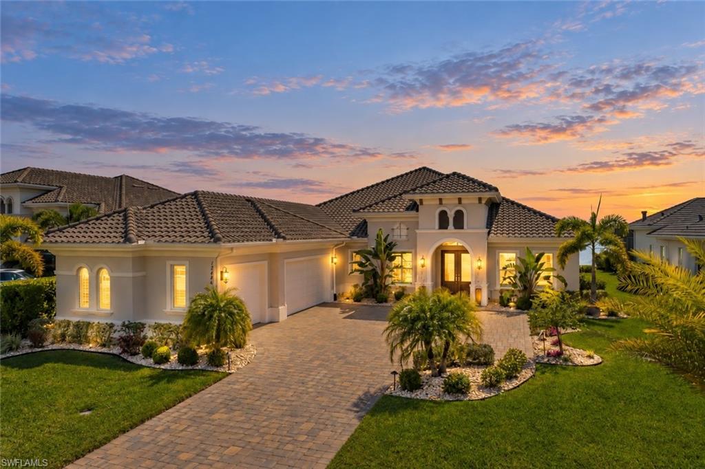 Beautifully positioned on a southern-exposure lakefront homesite in WildBlue, this Stock-built Sterling III with BONUS ROOM offers an exceptional blend of luxury, comfort, and effortless Florida living. The main living areas, wide water views and peaceful preserve scenery create a stunning backdrop throughout the day, with natural light filling the home and reflecting across the lake from sunrise to sunset.

Offering more than 3,707 square feet of living space, this thoughtfully designed floor plan includes 4 bedrooms, a private den, a generous bonus room, and 4 full baths. The layout provides tremendous flexibility for entertaining, overnight guests, working from home, or multigenerational living, while maintaining an open and connected feel.

At the heart of the home, the spacious kitchen features an oversized island, white cabinetry, a natural gas cooktop, professional-grade refrigerator, walk-in pantry, abundant storage, and an additional beverage cooler. The kitchen opens seamlessly to the great room, where crown molding, custom lighting, and expansive views enhance the home's polished yet comfortable atmosphere.

Indoor and outdoor living flow together beautifully through the oversized covered lanai. The outdoor space is designed for year-round enjoyment, featuring a natural gas-heated saltwater pool and spa, swim jet for lap-style exercise, a fully customized outdoor kitchen, and a spacious covered seating area ideal for entertaining or relaxing by the water. Storm Smart hurricane screens add convenience and protection, while professional landscaping and exterior lighting enhance the home both day and night. The lakefront lot also offers the opportunity to add a private dock in the future.

Meticulously maintained and showing beautifully, the home includes plantation shutters, remote room-darkening shades, and custom lighting throughout. Additional features include an air-conditioned 3-car garage, whole-home generator, whole-home water softener with reverse osmosis system, and a spacious laundry room with an additional full-size refrigerator.

Furnishings are available for purchase separately, with an inventory list available.

WildBlue is known for its exceptional resort-style lifestyle, with amenities including community pools, dining, fitness facilities, tennis, pickleball, boating lakes, and an active social calendar. This beautifully upgraded lakefront home combines quality construction, expansive living spaces, and an outstanding outdoor setting in one of Southwest Florida's most desirable communities.