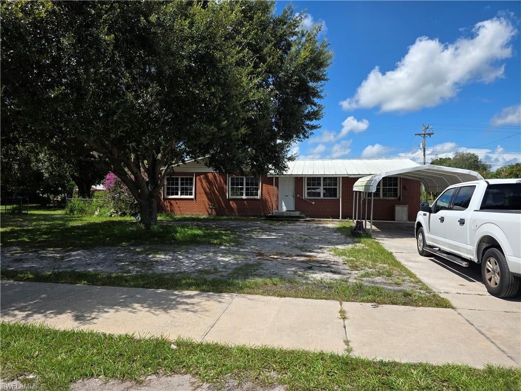Value-priced! This 3-bedroom, 2-bath home offers extra living space and sits on a rare .60-acre double-lot with city water and sewer. The property features a large corner lot, fenced yard, and a unique full-brick exterior that sets it apart from typical Southwest Florida homes. An adjacent buildable lot is included—zoned to allow a new single-family home or duplex, creating exceptional potential for expansion, investment, or multi-generational living. With a total lot size of 150' x 175', the space and flexibility are unmatched at this price point. The home needs some work, but the combination of land, brick construction, and development potential makes this a standout opportunity in Immokalee.
