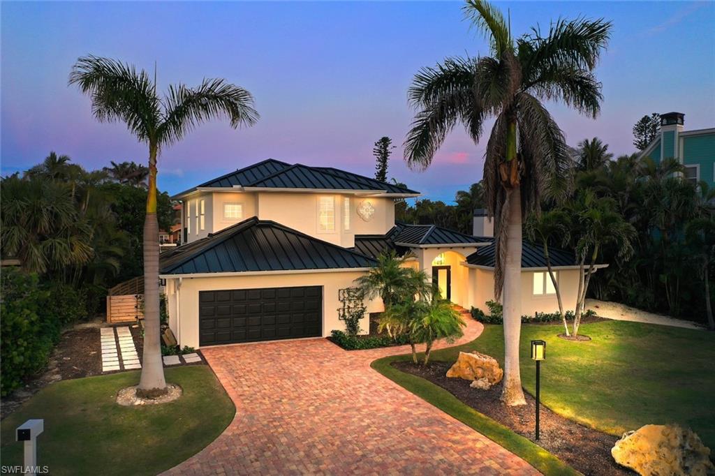 Boaters, take note—this is an exceptional Sanibel Island waterfront opportunity! Ideally positioned on the east end of the island, this breathtaking modern masterpiece offers superior boating access, private deeded beach access, and sophisticated luxury living in one extraordinary setting. Light-filled and airy, the thoughtfully designed residence showcases elevated shiplap ceilings, an expansive open floor plan, and walls of glass framing serene water views. Every detail has been carefully curated with high-end fixtures, exceptional finishes, and timeless modern design. At the heart of the home is a completely redesigned chef’s kitchen, combining style with exceptional function. Custom cabinetry, Rohl sink and faucets, and a premium Monogram appliance package—including built-in refrigerator and freezer, induction cooktop, wall oven, and microwave drawer—create a true culinary showplace. The generous island features an integrated ice maker and Elkay bar sink, making entertaining effortless. The kitchen flows seamlessly into the spacious great room and dining area, where large sliding doors open to the canal-front screened pool deck. Here, indoor and outdoor living merge beautifully, creating an ideal setting for relaxed afternoons, sunset gatherings, and year-round Florida entertaining. The luxurious primary suite is a serene retreat, featuring elegant alabaster pendant lighting and a cozy fireplace. The spa-inspired bath is finished with custom limestone herringbone flooring, Waterworks fixtures, a custom vanity, Robern mirrors, and a stunning backlit onyx feature. A beautifully designed custom walk-in closet provides abundant storage. With four spacious bedrooms and four-and-a-half baths, the home offers exceptional flexibility for family and guests. Two primary suites provide an ideal arrangement for multigenerational living or extended stays, while generously sized guest rooms comfortably accommodate king beds. A refined guest bath with marble flooring and custom vanity, plus an elegant powder room with stone flooring, Robern vanity, and marble faucet handles, further elevate the home. Outside, the screened pool area becomes a private waterfront oasis, offering sweeping canal views and plenty of space for al fresco dining and entertaining. For the boating enthusiast, the wide, deep-water, seawalled canal provides superior access, with your boat just moments from the Bay. An Azek dock and boat lift are ready for your next adventure. Additional highlights include private deeded beach access, epoxy garage flooring, Elkay chilled bottle filler, all-new plumbing and electrical systems, 2023 HVAC, 2023 standing-seam metal roof, newer gutters, and new LVP flooring on the stairs and upper level. With easy access on and off Sanibel from its coveted east-end location, this exceptional residence delivers the rare combination of luxury, design, beach access, and outstanding boating convenience—a truly remarkable Florida waterfront lifestyle.