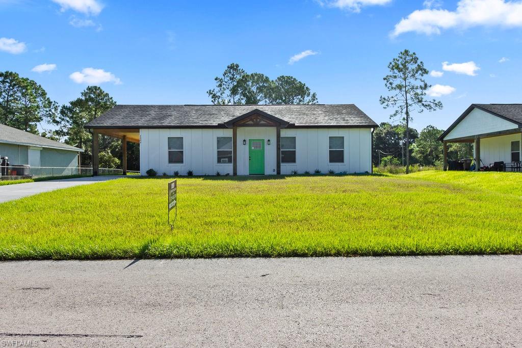 Modern Comfort & Easy Florida Living in Lehigh Acres! Built in 2025, this beautiful 3-bedroom, 2-bath home with a convenient carport offers the fresh, modern feel buyers are looking for with thoughtful features designed for everyday living. The open floor plan creates an inviting flow between the living, dining, and kitchen areas, making it easy to entertain guests or simply enjoy time at home.

Wood-look tile flooring runs throughout the home, providing a stylish look with easy maintenance. The kitchen features a pantry for added storage and functionality, while the spacious primary suite offers a private retreat with a walk-in closet and en-suite bath complete with dual sinks and a walk-in shower.

Step outside and enjoy your morning coffee or unwind at the end of the day on the covered front porch, beautifully framed with warm wooden beams that add character and curb appeal. The carport provides convenient covered parking and additional protection from the Florida sun and rain.

Ideally located near Frank Mann Preserve, outdoor enthusiasts can enjoy nearby opportunities to explore nature and the area's beautiful surroundings. You'll also be close to a variety of dining, shopping, and entertainment options, with easy access to local beaches and airports for convenient weekend getaways or travel farther afield.

Built in 2025 and ready to enjoy, this home offers the perfect combination of modern style, low-maintenance living, and a location that keeps Southwest Florida's many amenities within easy reach.