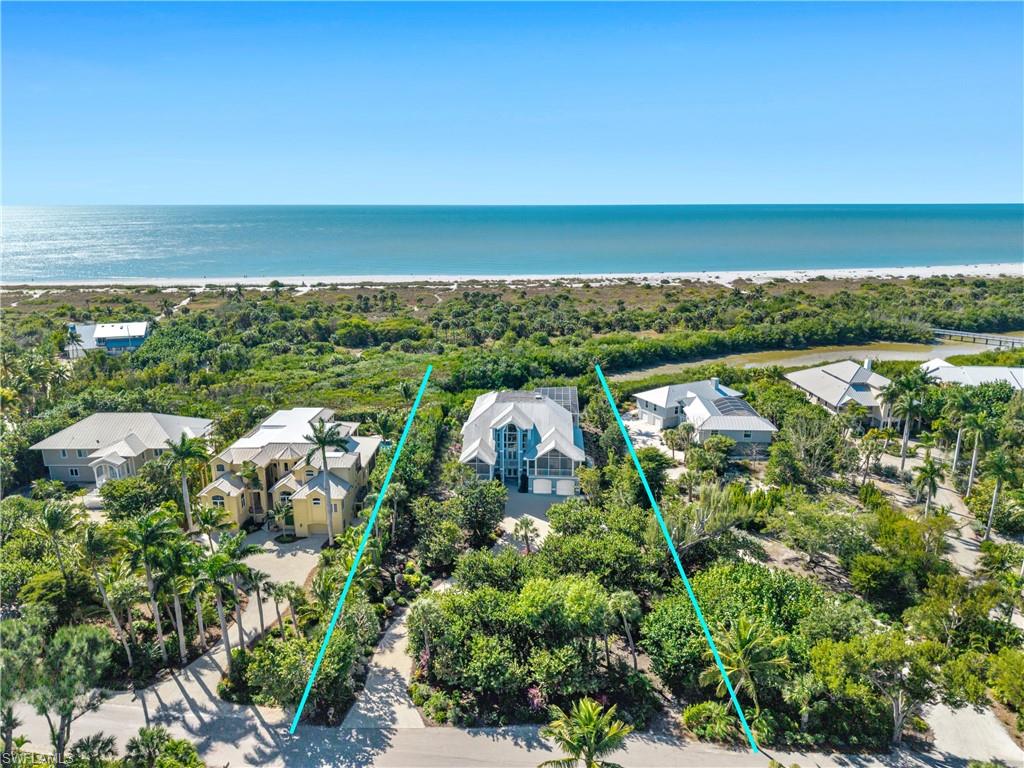 Tucked within the gulf-front enclave of Gulf Ridge, this coastal residence is defined by its rare positioning between a tranquil lagoon and the Gulf, offering sweeping water views, tropical privacy, and direct beach access. Thoughtfully designed across multiple levels, the home blends space, flexibility, and relaxed coastal living. The ground level is designed for outdoor enjoyment and everyday practicality, featuring direct access to the pool area with a newly enclosed screen, perfect for year-round use. A spacious multi-car garage provides ample storage for vehicles, bikes, and beach gear, making island living effortless. The main living level serves as the heart of the home, offering generous gathering spaces ideal for both daily living and entertaining. A well-appointed kitchen with an adjacent dining area anchors the floor, while the expansive living room opens to an enclosed patio overlooking the lagoon and lush surroundings. Three bedrooms and two bathrooms on this level provide comfortable accommodations for family and guests, all complemented by hurricane shutters for added peace of mind. The top floor is dedicated to a private primary retreat, creating a true sanctuary above it all. This level features a spacious bedroom with access to a private patio showcasing unobstructed lagoon and Gulf views, a spa-inspired bathroom with soaking tub and separate shower, and a walk-in closet. A morning kitchen and additional sitting area enhance the retreat-like feel, while an additional guest bedroom offers flexibility for visitors or extended stays. Surrounded by mature tropical landscaping and set in one of the area’s most desirable gulf-front communities, this home offers a rare opportunity to enjoy privacy, water views, and beach access in a thoughtfully designed coastal setting.