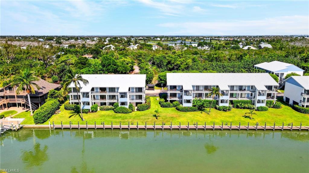 Wake up to breathtaking canal views, gentle coastal breezes, and dolphins and manatees gliding by from this beautifully positioned second-floor end residence at Tennisplace. Ideally located at the end of the community, this move-in-ready, turnkey furnished condo offers privacy, panoramic water views, and the effortless island lifestyle you've been dreaming of.

Perfectly situated on Sanibel's east end, Tennisplace provides quick on-and-off island access while placing you just moments from bayside beaches, waterfront dining, shopping, and miles of scenic bike paths. It's the ideal island getaway for Southwest Florida residents who live off-island but have always dreamed of owning their own weekend retreat—escape the traffic, leave the mainland behind, and enjoy boating, shelling, beach walks, and spectacular sunsets whenever you choose.

Life at Tennisplace is all about enjoying the outdoors. Relax by the heated pool, play a match of tennis or pickleball, launch your kayak or paddleboard, stroll to the deeded beach access, or set out from Tennisplace dockage with direct Gulf access. Dockage is equipped with water and electricity, making it easy to spend your days on the water.

Recent community improvements include new roofs, freshly painted buildings, and a brand-new dock system, while the absence of current assessments provides added peace of mind. Whether you're looking for a full-time residence, a seasonal escape, the perfect weekend retreat, or an investor-friendly vacation rental, this exceptional waterfront property offers everything you need to embrace the Sanibel lifestyle. Your island paradise is waiting.