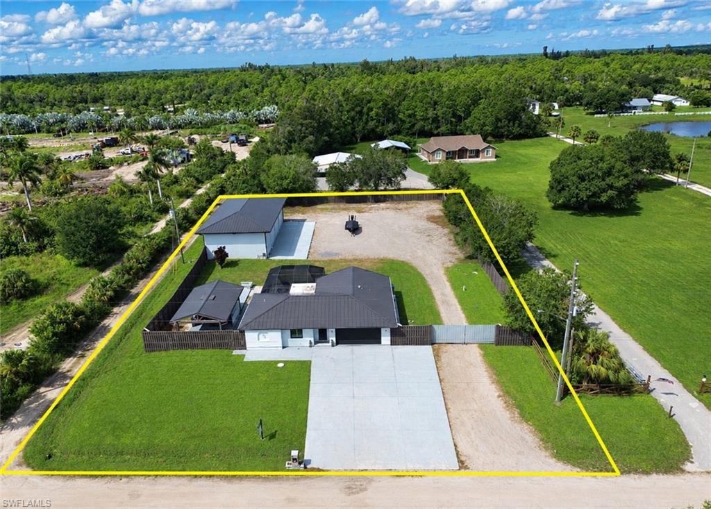 Your Private North Fort Myers Retreat on 1.13 Acres!

Welcome to a property that truly has it all—space, privacy, entertainment, and an incredible setup for car enthusiasts, hobbyists, or anyone needing a serious workshop! Situated on 1.13 fully fenced acres in North Fort Myers, this home offers the perfect combination of comfortable living and exceptional outdoor amenities.

The property features an attached 2-car garage plus an impressive detached 3-bay shop/garage complete with a car lift, providing outstanding space for vehicles, boats, recreational toys, projects, storage, or a home workshop.

Step outside and discover your own private backyard oasis designed for entertaining. Enjoy Florida living year-round with a swimming pool, fire pit, and outdoor cooking area—the perfect setting for weekend gatherings, family cookouts, or relaxing evenings under the stars. With over an acre of fully fenced property, there is plenty of room to spread out and enjoy the privacy and versatility this property provides.

Adding even more value and convenience, the home is equipped with a whole-home reverse osmosis water system & a WHOLE HOUSE propane standby generator!

Properties offering this combination of acreage, a pool, extensive garage and shop space, a car lift, outdoor entertaining amenities, and a fully fenced yard are hard to find. Whether you're looking for room for your vehicles and toys, a place to entertain, or simply more space and privacy, this North Fort Myers property delivers the Florida lifestyle you've been looking for!