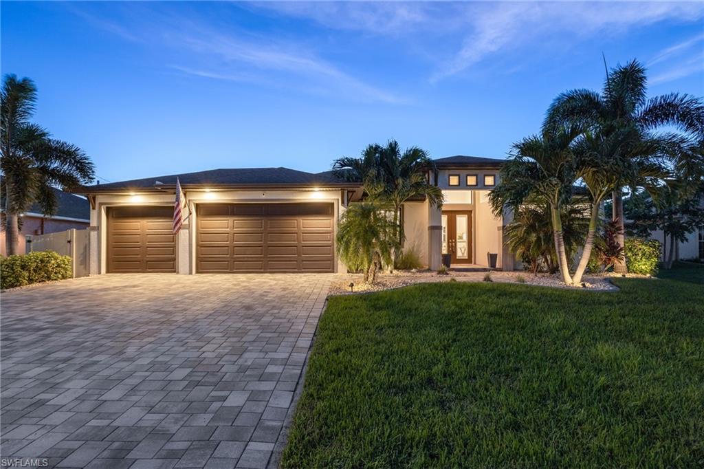 This is the kind of home that makes you slow down, take a breath, and picture yourself living the Florida lifestyle you’ve been dreaming about.

Located in the heart of Southwest Cape Coral, this beautifully designed three-bedroom plus den home feels better than new from the moment you arrive. The curb appeal is striking, with lush landscaping, elegant lighting, and towering Royal Palms welcoming you home. A pavered driveway leads to the three-car garage and sets the tone for the quality and care you’ll find throughout.

Step through the double front doors and you’re greeted by a bright, open space that instantly feels warm and inviting. The living, dining, and kitchen areas flow together effortlessly, creating a layout that’s perfect for both everyday living and entertaining. The kitchen is the heart of the home, featuring a large island, walk-in pantry, upgraded lighting, and clean, modern finishes that make hosting friends or family a joy. Tile flooring throughout and tray ceilings add a polished, coastal feel that’s both stylish and timeless.

The den, tucked behind French doors, is incredibly versatile and works beautifully as a home office, media room, or extra space for guests. The primary suite feels like a true retreat, with a spacious bathroom designed for comfort and relaxation.

But the real magic happens when you step outside. Pocket sliding doors open to a private backyard oasis that truly defines Southwest Florida living. The expansive lanai features a heated saltwater pool, a full outdoor kitchen, and plenty of space to lounge, entertain, or simply unwind. Whether you’re enjoying sunny afternoons by the pool, watching TV outdoors in the evening, or taking in breathtaking western sunsets, this space was made to be enjoyed year-round. An electric canopy offers shade when you want it, and the fenced backyard provides privacy and peace of mind.

Thoughtful details continue throughout the home, including impact-resistant windows and doors, an oversized laundry room with extra storage and a sink, and immaculate landscaping with even more Royal Palms. Furniture is negotiable, making this an easy move-in-ready opportunity.

Even better, you’re just a quick electric bike ride from downtown Cape Coral, where dining, shopping, nightlife, and seasonal events are all right at your fingertips.

This isn’t just a house, it’s a lifestyle. Modern design, a prime location, and a backyard retreat that feels like a private resort all come together in one exceptional home. Opportunities like this don’t come around often. Come see it for yourself and fall in love.