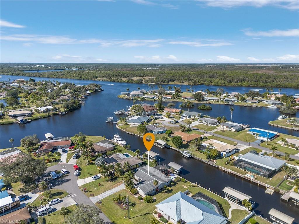 Exquisite Gulf Access WATERFRONT Living - Indulge in the epitome of COASTAL luxury with this FULLY REMODELED GULF ACCESS home nestled in the heart of Southwest Florida in the HIGHLY SOUGHT AFTER RIVER FOREST COMMUNITY! Beyond its beautiful interiors of slightly over 2,000 sq ft of living area, this residence boasts 90' OF WATER FRONTAGE, SEAWALL, and private DOCK and LIFT, inviting you to explore the waterways of the CALOOSAHATCHEE RIVER which meets Gulf of Mexico and also brings you to the EAST COAST of FL. MODERN design and UPSCALE finishes harmonize to create a stylish and COMFORTABLE LIVING SPACE. Enjoy the expansive LIVING ROOM which opens to the SPACIOUS FAMILY ROOM! The SPACIOUS KITCHEN features NEW CABINETRY & FIXTURES AND WHITE APPLIANCES. BOTH bathrooms offer NEW cabinetry and fixtures! The Primary Bedroom has an EXTRA BONUS ROOM perfect for an office, or craft room! The outdoor living spaces are an extension of the home, with a covered SCREENED PAVERED lanai, HOT TUB and lush landscaping. Other FEATURES: AC 2023, COMPOSITE DECKING DOCK & 10,000# LIFT with power & water and ROOF 2017. Whether you're hosting a barbecue or simply unwinding by the HOT TUB, every day feels like a vacation. River Forest has a voluntary association and is very ACTIVE! Members gain access to a community boat ramp and clubhouse, adding to the appeal of this exceptional property. Embrace the RELAXED WATERFRONT lifestyle!