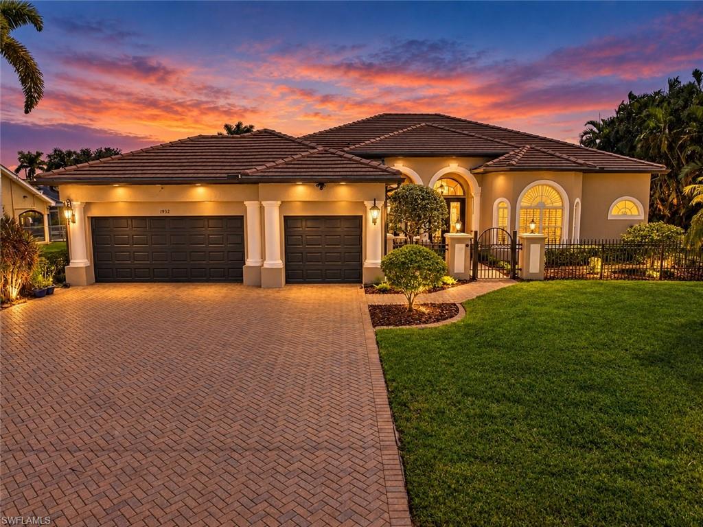 From the moment you enter through the gated courtyard, breathtaking intersecting canal views steal the show at this exceptional GULF-ACCESS waterfront home! Welcome to your slice of paradise in Cape Coral's desirable Four Mile Cove SE Enclave. Framed by pristine landscaping, stately concrete columns and timeless Mediterranean architecture, this custom-built Arthur Rutenberg Manchester home blends coastal living with thoughtful design. Set on an oversized 0.34-acre, three-lot property with 120 feet of seawall and an estimated 19-minute boat ride to open water, this is Gulf-access Florida living at its finest!

Inside, discover 2,670 square feet of beautifully designed living space and 3,354 square feet in total, with sweeping canal views from the main living areas, open kitchen and primary suite. The split-bedroom floor plan offers 3 bedrooms plus a den, 2 full baths and a half bath. Eight-foot doors, crown molding, leaded-glass entry doors with Baldwin hardware and upgraded wood shelving in every closet add custom charm. The open kitchen features a Miele dishwasher with water-softening feature and a newer microwave. The primary suite offers dual walk-in closets, an ensuite bath and sliders to the lanai.

And let's talk about outdoor living! An extraordinary 62-foot picture-window lanai screen puts those panoramic water views on full display. Imagine slow mornings with coffee by the water, sunny afternoons beside the resurfaced pool (2023) and spa with 12-panel solar pool heating (2023), and evenings entertaining around the outdoor kitchen with sink, propane grill, refrigerator and TV. A newer variable-speed pool pump adds efficiency. Sliders from the living room, family room and primary suite connect indoors and out, while motorized shades on all lanai doors add comfort at the touch of a button.

Love being on the water? Your private setup includes premium WearDeck dock decking, a full captain's walk, 7,000-pound boat lift and protective canopy. There's even a separate dockside sitting area, perfect for sunset drinks or watching boats cruise by. Head out to explore Southwest Florida's waterways, then return to your peaceful waterfront retreat.

The three-car garage features polyaspartic flooring, built-in shelving, insulated doors and an electrical transfer switch for generator hookup. A 2023 flat tile roof and gutters, 2019 HVAC, 2025 water heater with recirculation, Rain Bird digital irrigation and full hurricane protection add everyday comfort and ease.

With no HOA fees, breathtaking canal views and boating adventures right outside your door, this home also includes a one-year home warranty for added peace of mind as you settle into your new slice of paradise. All that's left to do is soak up the sunshine and start living the coastal dream!