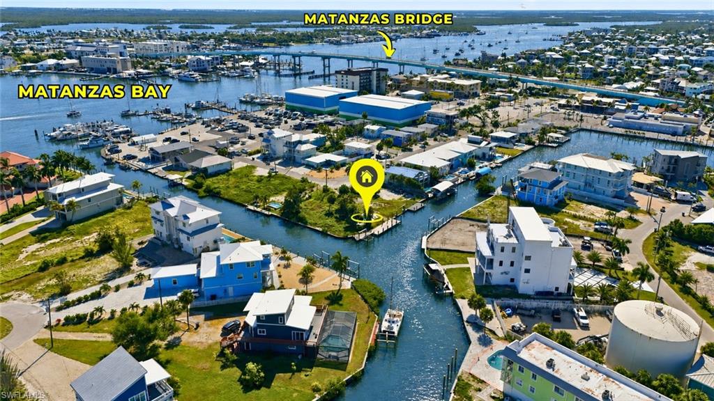 One or more photo(s) has been virtually staged, AI generated or rendered.  Exceptional Gulf-Access Waterfront Homesite with New Dock & Boat Lift – Prime Fort Myers Beach Location.  Build a luxury 5-bedroom, elevated vacation home designed for today's rental market with the potential to generate $250,000+ in annual gross rental income (buyer to verify). Whether you're building for personal enjoyment, investment, or both, this location consistently attracts vacationers seeking the ultimate beach-and-boating experience. Located within a highly desirable weekly vacation rental zone, this property presents an outstanding opportunity.

Build your dream coastal retreat or a high-performing investment property on this exceptional Gulf-access waterfront homesite in the heart of Fort Myers Beach. Situated on a deep, navigable canal with direct Gulf access and no bridges, this premier waterfront lot offers effortless boating with quick access to Estero Bay and the Gulf of Mexico.

A brand-new dock spans the length of the seawall and is complemented by a new boat lift, providing immediate enjoyment while you plan your custom waterfront residence. The property also includes a fully operational swimming pool, a rare bonus that adds immediate value and flexibility.

Perfectly positioned just minutes on foot to the sugar-sand beaches of the Gulf of America, you'll also enjoy an easy walk to Times Square, the Pier District, Margaritaville Resort, waterfront restaurants, shopping, and entertainment, allowing you to experience the very best of the Fort Myers Beach lifestyle.

Multiple respected local builders are available to assist in designing and constructing your custom coastal home, making the building process seamless from concept to completion.

Rare opportunities combining direct Gulf access, no bridges, a new dock and boat lift, a working pool, walkability to the beach, and proximity to Times Square are becoming increasingly difficult to find. Secure your piece of paradise and create the waterfront lifestyle you've always envisioned.