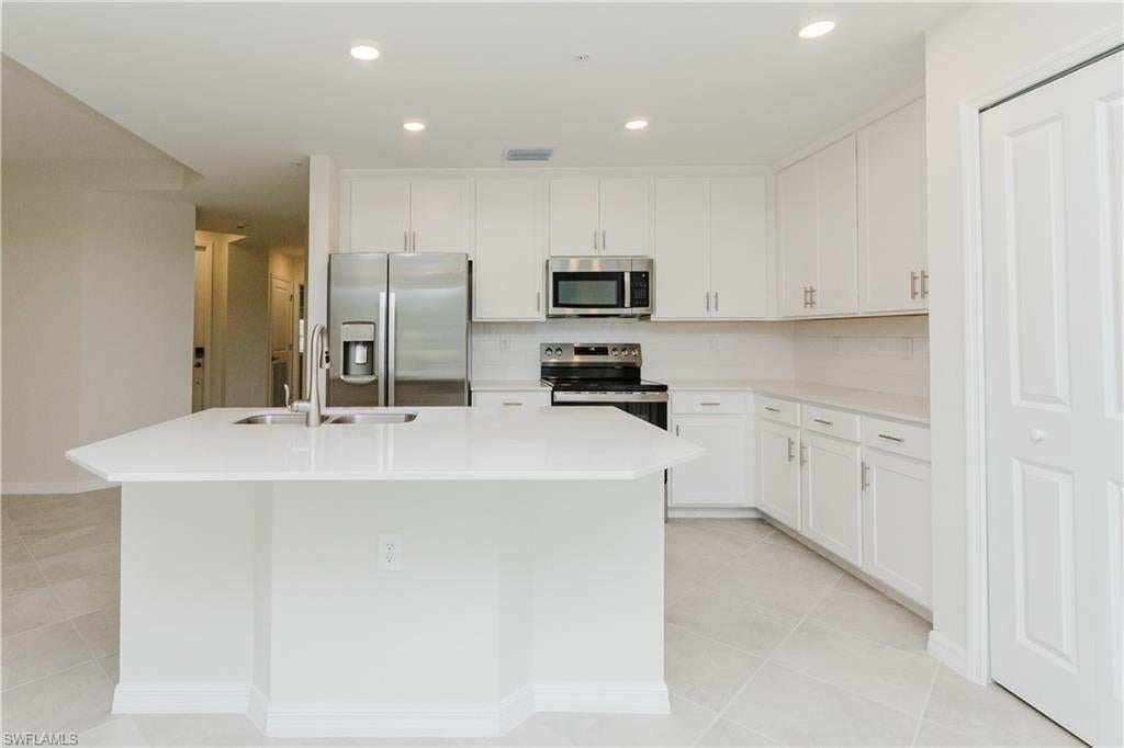Welcome to this beautiful new Carolina floor plan condo, ideally located in Lehigh Acres. This first-floor residence offers a bright, open-concept layout with modern finishes and thoughtful upgrades throughout. Enjoy the convenience of tile flooring throughout the entire home, creating a clean and elegant look that is easy to maintain. The home features new light fixtures, adding a fresh and modern touch to the living spaces. The sliding glass door is equipped with curtains for added privacy, while the front entrance and lanai are screened, allowing you to enjoy the Florida lifestyle comfortably. The Carolina floor plan offers a spacious and functional design with comfortable living areas, a well-appointed kitchen, and inviting spaces for relaxing or entertaining. This new condo is move-in ready and offers a wonderful opportunity to enjoy low-maintenance Florida living. Schedule your private showing today!