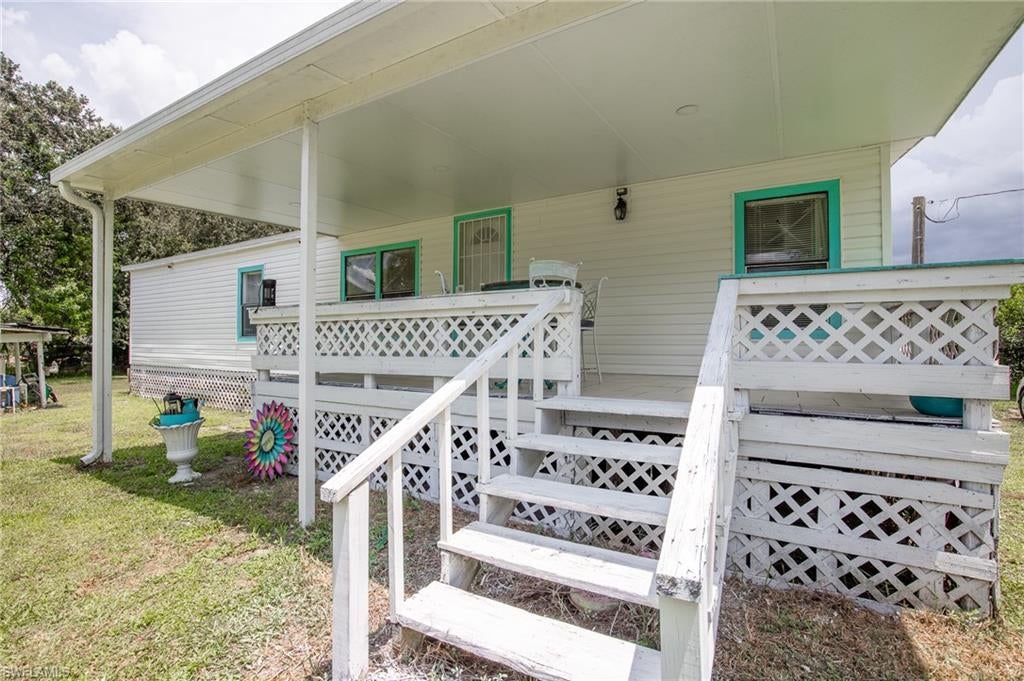 This spacious double-wide manufactured home, built in 1990, offers 3 bedrooms, 2 full baths, and a versatile bonus room—all within 1,404 sq ft of comfortable living space. Step onto the inviting front or back porch and breathe in the fresh country air, surrounded by citrus trees and a fully fenced, cross-fenced yard. A large shed with covered storage adds practical convenience, while the inside laundry room and generous kitchen with pantry closets make daily life a breeze.
Beyond the home, enjoy exclusive access to Montura Ranch’s vibrant amenities: splash around in the pool with slides, unwind in the clubhouse, challenge friends to basketball or volleyball, explore the park and library, or venture out on scenic trail rides and wildlife viewing—all included with your property.