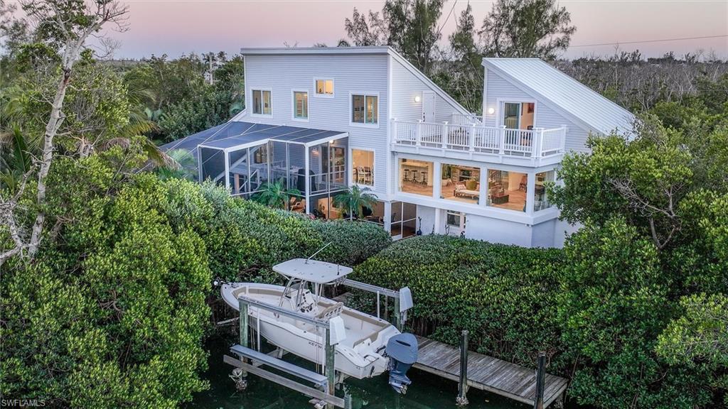 Luxury Waterfront Living with Direct Canal Access on Sanibel Island
Experience refined island living in this beautifully renovated 3-bedroom, 2.5-bath waterfront home, complete with an office and canal-view lounge, ideally situated on a quiet no-through street in one of Sanibel’s most peaceful neighborhoods.
Set along one of the island’s widest canals, this exceptional property offers direct, no-bridge boating access with sweeping down-canal views toward Pine Island, all framed by mangroves and abundant wildlife. The open, light-filled floor plan is designed to capture water views from nearly every window, creating a seamless connection between indoor living and the surrounding natural beauty.
A rare and defining feature of this property is its exceptional level of privacy. With no homes directly across the street and strategic positioning that limits visibility of neighboring properties, the pool, backyard, and primary living areas feel remarkably secluded—creating a true sense of retreat rarely found in canal-front homes.
The office and adjoining canal-view lounge offer a serene space for work or relaxation, while the main living areas flow effortlessly for everyday living and entertaining. The chef-inspired kitchen has been thoughtfully upgraded with custom cabinetry, quartz countertops, a wine chiller, large LG French-door refrigerator, convection double ovens, Wolf induction cooktop, designer Zephyr ventilation hood, and Whirlpool dishwasher—blending high-end performance with modern coastal elegance.
Interior improvements include impact-rated windows, sliders, and doors, luxury vinyl plank flooring throughout, recessed lighting, updated ceiling fans, and a well-appointed laundry room with counter space and utility sink.
Outside, the home continues to impress with an oversized pool enclosed by a no-see-um screened cage, pressure-treated marine-grade decking with PolyRail vinyl railing, and a 30-foot dock with water, electric, and a 10,000-pound boat lift. With direct canal access and no bridges to the bay, this is a true boater’s retreat—enhanced by the quiet, private backdrop.
Additional highlights include a 2017 roof, Trane A/C system, garage with recessed doors and full-chip polyurethane floor coating, extended storage room off the pool area, bonus storage beneath the stairs, new soffit, fascia, downspouts, siding, irrigation, and beautifully maintained gardens that further enhance both privacy and curb appeal. Excellent spacing between neighboring homes adds to the sense of peace and seclusion.
Centrally located with easy on-and-off island access, walking distance to the bay, and surrounded by nature, this home offers a rare blend of luxury, privacy, and premier boating access—an exceptional opportunity to own a fully updated waterfront retreat on Sanibel Island.