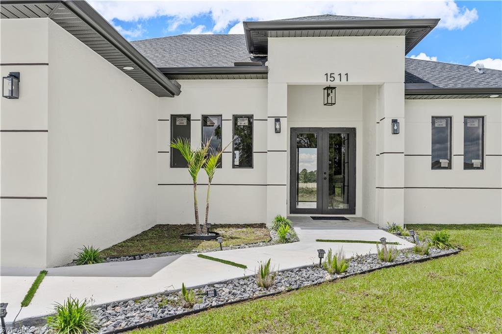 Stunning New Construction on a Cleared Half Acre Lot! This beautifully built home features an open-concept layout with high ceilings, oversized tile flooring, and abundant natural light. The spacious living area showcases a custom accent wall with a sleek linear fireplace. The kitchen offers a large island, contemporary cabinetry, and stylish finishes throughout. Bathrooms include designer vanities and walk-in glass showers. Enjoy outdoor living with an outdoor kitchen and convenient half bath. Complete with a 2-car garage and modern curb appeal, this home is move-in ready and perfect for comfortable, stylish living.