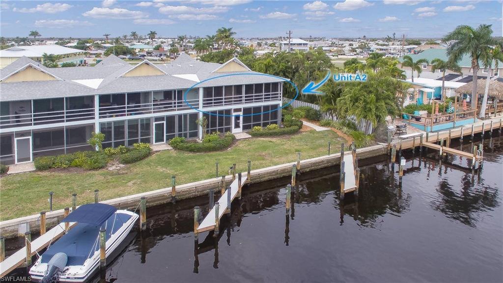 YOUR TURNKEY PINE ISLAND WATERFRONT GETAWAY IS HERE! Escape to island time with this fully furnished 2-bedroom, 2-bath second-floor condo offering direct Gulf access, boat facilities, a heated community pool, and an easy, carefree Florida lifestyle. Located in Fisherman's Wharf, this 1,053-square-foot retreat is ready to enjoy from day one. The unit features vaulted ceilings, tile flooring, updated lanai windows with screens, and a hurricane-rated front door. The community has undergone major improvements, including new roofs, exterior paint, new railings, updated stair and concrete walkways to units on both floors,  and electrical and plumbing upgrades. Bring your boat, fishing gear, and flip-flops and start enjoying Pine Island's legendary waterways. Boat slips and secure boat/trailer storage make this an especially appealing option for boating enthusiasts, while the turnkey furnishings make it equally attractive as a seasonal escape or full-time island home. Leave the mainland behind—your Pine Island adventure starts here.