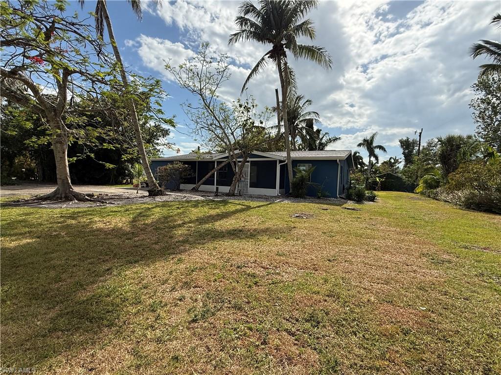 Enjoy the laid-back Pine Island lifestyle in this 3-bedroom, 2-bath home situated on over half an acre in Bokeelia. The home offers an open great-room layout with vaulted ceilings, impact-resistant windows, and a newer roof. A separate attached living area with its own entrance and full bath provides additional flexibility for guests, extended family, a home office, or additional living space.

Step outside to the large screened lanai overlooking a spacious backyard with mature landscaping and plenty of room for a pool, garden, boat, RV, or outdoor entertaining. With no HOA, you have the freedom to make the property your own.

Located near the heart of Bokeelia, you're convenient to public boat ramps, the Bokeelia Fishing Pier, waterfront dining, and access to Pine Island Sound, Charlotte Harbor, and some of Southwest Florida's best boating and fishing.

Property is being sold AS-IS. Potential short sale; sale price and terms are subject to third-party/lender approval.