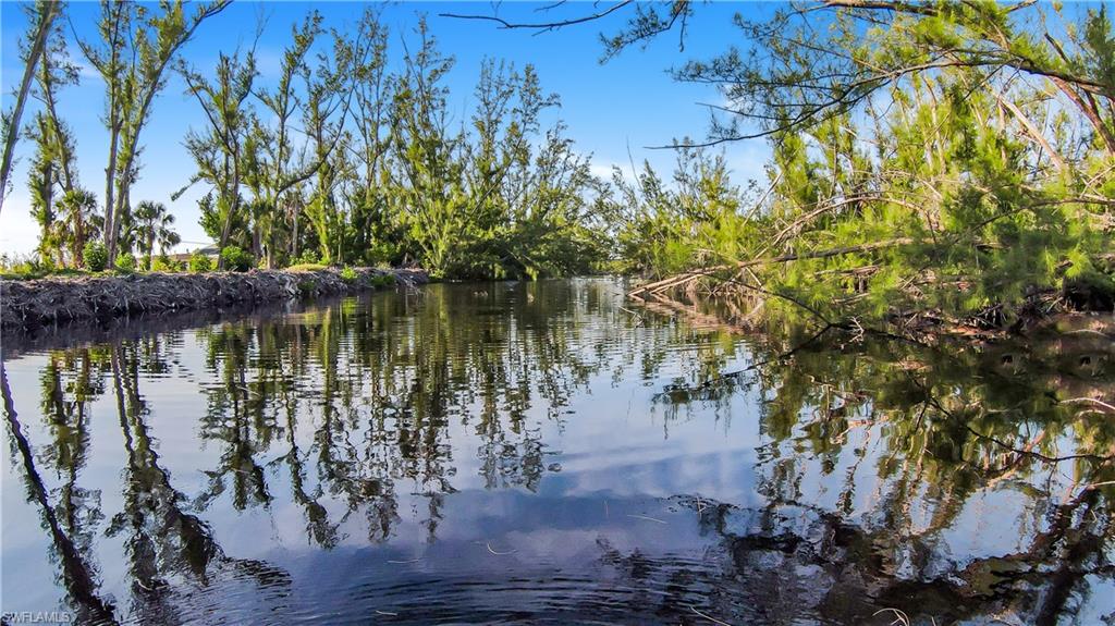 We are proud to bring you a slice of tropical paradise! This 80x100 vacant homesite at 3651 Crestwell Cr, nestled in Saint James City's sought-after St. Jude Harbors, is a true gem awaiting your dream abode. Surrounded by lush preserve land, this waterfront haven on a freshwater canal offers an idyllic blend of tranquility and convenience. Immerse yourself in the vibrant ambiance of Pine Island, as you revel in the gentle caress of the balmy breeze and the mesmerizing melody of the nearby canal. Indulge in the sheer delight of strolling to the array of delightful eateries, casting your line at nearby prime fishing spots, or exploring the enchanting walking trails. With city water and electricity readily available, seize the opportunity to craft your own tropical oasis. Come, envision your ideal sanctuary amidst this captivating natural haven!