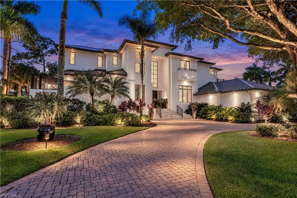 Grand in scale & sophisticated in design, this stately 6,000-plus-square-foot luxury single-family home with a THREE-CAR GARAGE occupies an exceptionally private setting in Creekside at Bonita Bay in Bonita Springs, Florida. Sweeping lake & golf course views, impressive architectural proportions & expansive outdoor living spaces distinguish this remarkable residence within spectacular Bonita Bay. Substantial improvements complement its timeless character, creating a home equally suited to gracious entertaining & relaxed everyday living.
Extra-tall ceilings on both levels establish a striking sense of scale, while expansive glass doors frame the surrounding landscape. Redesigned openings in the primary bedroom, formal living room & family room feature dual-direction, 10-foot-tall sliding doors with openings up to 18 feet wide. These dramatic expanses connect the interiors with generous covered porches & the screened pool terrace, inviting you to enjoy the views from every perspective. The south-facing backyard offers a wonderfully private retreat, with an oversized saltwater pool featuring a deep end & ample space for lounging, dining & gathering. Covered porches provide shaded places to relax, while long views across the lake & newly redesigned Creekside 10th hole create a magnificent backdrop. Exceptional separation from neighboring homes, both front & rear, enhances the sense of seclusion. Extensively renewed landscaping includes carefully reshaped mature trees, refreshed gardens & a redesigned orchid garden adjoining the primary suite. Inside, a soundproofed movie room provides a dedicated entertainment space, while a private elevator offers convenient access between floors. A generous storage room, central vacuum & upgraded zoned sound system add thoughtful functionality. Audio extends through the primary bedroom, entry halls, formal living room, office, family room & kitchen.

Extensive improvements include a new roof in 2023, additional insulated roofing in 2025, fresh paint throughout the home & new ovens. Premium French doors opening to both upstairs balconies have been replaced, & the balconies have been waterproofed. Pool improvements include two new pumps, a heater, circulation components, lights, pressure tank & a new saltwater system. Updated irrigation timers & zones, new garage door equipment & storage racking in the three-car garage further enhance everyday convenience. For buyers seeking a distinguished luxury home in Creekside at Bonita Bay, this residence brings together extraordinary privacy, architectural presence & a spectacular lake & golf course setting. Spacious interiors & inviting outdoor retreats offer the opportunity to enjoy Bonita Springs, Florida, living on a grand scale—a home whose proportions, views & distinctive character deserve to be experienced in person. Bonita Bay’s scenic trails, lush preserves & waterfront beauty offer an extraordinary setting for an active Florida lifestyle.
