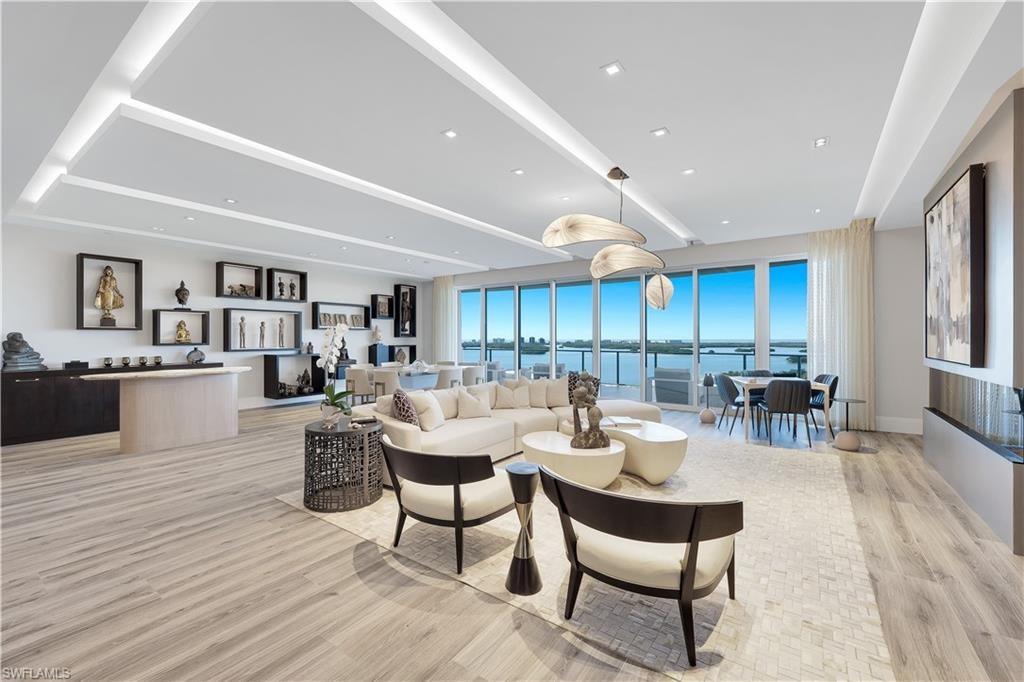 The ULTIMATE IN LUXURY! This is the home in the sky you’ve been waiting for — offering breathtaking, panoramic views and expansive interiors designed for effortless indoor-outdoor living. Located in OMEGA, Bonita Bay’s newest and most coveted high-rise, this exceptional residence delivers both privacy and prestige. Spanning 4,210 square feet, the home features three beautifully appointed bedrooms, a private den, and three-and-a-half baths, all thoughtfully designed with sophistication and comfort in mind. A private elevator opens directly to the 11th-floor residence, where a gracious foyer sets the tone for the refined living that follows. The open-concept interior is framed by floor-to-ceiling glass, capturing uninterrupted views of Estero Bay, the Gulf of Mexico, and the surrounding golf course while flooding the home with natural light. Soaring 10’4” ceilings, designer lighting, and elegant flooring elevate the space with timeless appeal. At the heart of the home, the gourmet kitchen seamlessly blends style and function, featuring premium appliances, refined finishes, and a layout ideal for both entertaining and everyday living. The expansive living and dining areas flow effortlessly to an extraordinary 78-foot-wide terrace, creating a stunning backdrop for entertaining or quiet evenings at sunset. The oversized covered lanai is designed for year-round enjoyment, complete with a fully equipped outdoor kitchen and gas grill, offering the perfect setting for al fresco dining and gatherings. The primary bedroom is a private retreat, featuring an ensuite bath and walk-in closet, while the additional guest bedrooms are located on the opposite side for the home, providing comfort and privacy for both residents and guests. Additional highlights include impact-resistant glass, a two-car air-conditioned garage on the second level, and an additional parking space conveniently located next to the elevator. Residents of Bonita Bay enjoy an unmatched lifestyle with access to a private beach club, kayaking and canoeing, pickleball and tennis, multiple parks, and more than 12 miles of walking and biking paths. Golf enthusiasts will appreciate five championship courses, along with multiple dining venues, a state-of-the-art fitness center, and a full-service marina (club membership required; additional fees apply). Ideally located just minutes from world-class dining, shopping, beaches, and nature preserves, with easy access to Downtown Bonita Springs, Downtown Naples, and RSW International Airport, this residence offers the perfect balance of luxury, convenience, and coastal living.