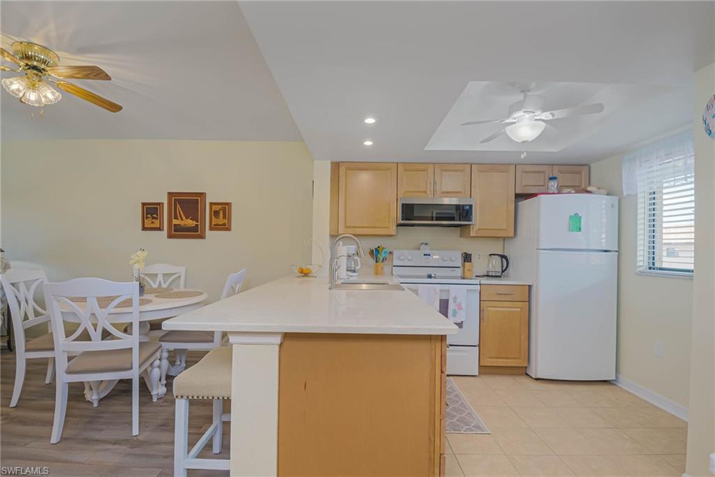 ***SELLER WILL PAY 6 MOS OF CONDO FEES AT CLOSING WITH AN ACCEPTABLE OFFER AND A CLOSING ON OR BEFORE NOVEMBER 30, 2026***Discover this stylish, 55+, TURNKEY, and move-in ready condo nestled in a gated community in the heart of Fort Myers. Located in a quiet rear section of the complex, this unit offers both privacy and convenience. Step inside to an open-concept layout featuring newer flooring and a beautifully updated kitchen with rich maple cabinetry, perfect for entertaining or everyday living. The condo boasts two spacious bedrooms, each with modernized bathrooms, offering comfort and functionality. Enjoy the convenience of in-unit laundry and unwind on the screened lanai, which overlooks the community pool and lush green space—ideal for relaxing with a morning coffee or evening drink. Whether you're looking for a seasonal retreat or full-time residence, this condo checks all the boxes with its central location, updated finishes, and peaceful setting within a secure gated community.