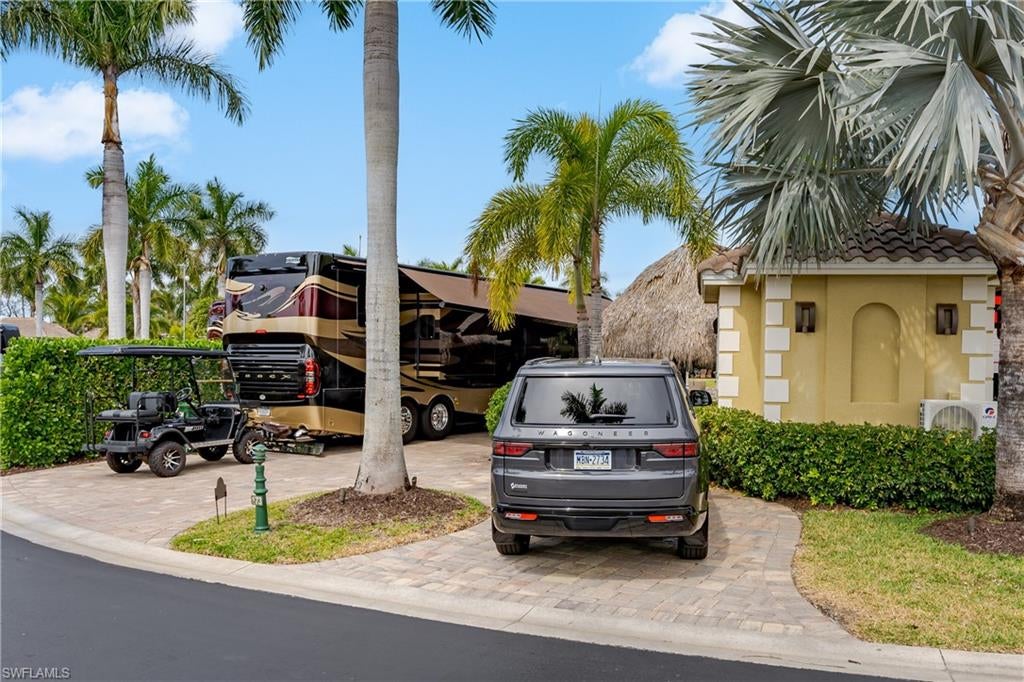 Lot 173 – Welcome to your own private resort retreat in Naples Motorcoach Resort! From the moment you enter this beautifully landscaped, gated Class A Motorcoach Resort, pass the impressive entrance fountains and arrive at the magnificent clubhouse overlooking the lake, you know you have arrived somewhere special.

Follow the lake to Lot 173, an exceptional oversized lakefront property offering one of the resort's most desirable settings and an incredible amount of outdoor living and entertaining space. Pull into your fully paved circular drive and discover a property designed to make the most of the Southwest Florida motorcoach lifestyle.

The fully air-conditioned casita provides generous additional living space along with a large bathroom, creating the perfect extension of your coach. Adjacent to the casita is an expansive tiki with abundant seating and plenty of room to entertain family and friends. And the outdoor living doesn't stop there! Two additional seating areas provide even more places to relax, including a fully gated lakeside area offering front row views of the lake and fountain; an especially wonderful spot to enjoy the outdoors while keeping your four legged companion comfortably by your side.

The view is truly special. From your property, look directly across the lake and fountain toward the resort's man-made beach, infinity pool and clubhouse, a beautiful backdrop whether you are enjoying your morning coffee, entertaining friends or relaxing at the end of the day.

Despite all of its improvements and multiple entertaining areas, this oversized property still comfortably accommodates a 45-foot motorcoach, vehicle and golf cart. The combination of space, improvements, landscaping and exceptional lakefront location makes Lot 173 a property that truly needs to be experienced in person.

Naples Motorcoach Resort is an exclusive Class A only resort offering an impressive array of amenities, including a spectacular infinity pool overlooking the lake and beach, two additional satellite pools, hot spas, fitness center, men's and women's saunas, clubhouse with kitchen and gathering spaces, laundry facilities, pickleball courts and a dog park. The resort's boat ramp provides access through the surrounding waterways toward Rookery Bay, Marco Island and the Gulf.

Whether you're looking for a winter escape, an extended seasonal retreat or your own piece of the Naples resort lifestyle, Lot 173 offers the space, setting and amenities to make it truly feel like your home away from home. This is one you don't want to miss!
