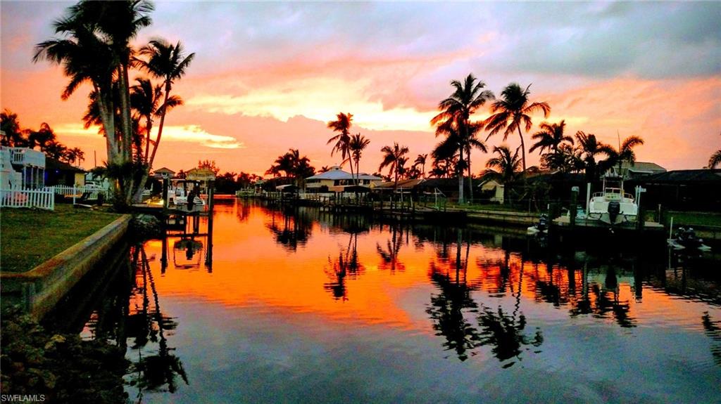 Check out the 100’ Wide Canal View from the upstairs, screened Lanai that overlooks the 40' Pool and 2 Docks! There are 2,498 finished, air conditioned sq. ft. with 1,546 sq. ft. upstairs in the 3-bedroom, 2 bath split plan. Downstairs is another 852 sq. ft. of finished space with a pool bath, which is used as a poolside gathering room but is considered uninsured area. The spacious 2-car garage also has new doors and a workshop area. The residence's extended drive allows parking for your various vehicles without restrictions. The 75 ft. wide riprap seawall supports the fishing dock and docks where you can hop on your boat or jet ski and be in the Gulf in 20 minutes! Complete with a metal roof the home is on a filled lot and the elevated structure keeps the living quarters high and dry. This stylish 'Old Florida' waterfront home offers so much more than meets the eye! See it soon and start 'LIVING YOUR FLORIDA DREAM!'