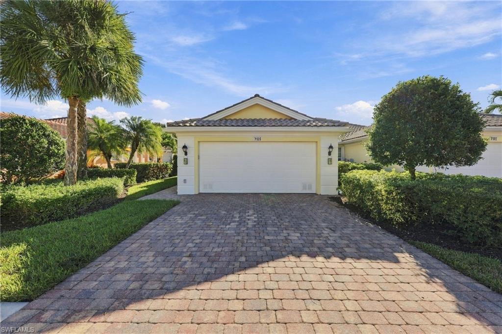 One or more photo(s) has been virtually staged, AI generated or rendered.  Welcome to 7128 Marconi Court, a Capri model featuring original DiVosta poured concrete construction that includes smooth coat walls, finished closets, and central vac.  Upon entering the home, you immediately notice the vaulted ceiling and abundant natural light.  The Capri model consists of a split 2 bedroom floor plan offering complete privacy and two ensuite bathrooms.  The private owner's suite and guest suite are thoughtfully positioned on opposite sides of the home and both include walk-in closets.  The centrally located kitchen offers generous cabinetry, expansive counter space and breakfast bar overlooking the spacious great room and multi use open den area.  A fully functional laundry room includes additional pantry space and leads directly to your two car garage.  The screened in lanai provides year round enjoyment blending privacy, comfort, and beautiful lakefront scenery.  Included in your low HOA fees are lawn irrigation and maintenance, tree and shrubbery trimming, in-home security system, basic cable and internet access.  Life in VeronaWalk means 24-hour guard gated security, a resort pool and lap pool, tennis, pickleball, bocce and basketball courts, 24-hour state of the art fitness center, and over 20 miles of scenic biking and walking trails.  The town center offers a gas station, restaurant, ice cream shop, hair salon, travel agency, post office, library, and function rooms.  A full-time Activities Director provides for a year-round calendar full of vibrant activities and community events.  VeronaWalk  is ideally located just minutes from downtown Naples, Marco Island, world-class Gulf Beaches, premier shopping, fine dining, golf, and medical facilities.  This home offers an outstanding opportunity as a full-time residence, seasonal retreat, or investment property.