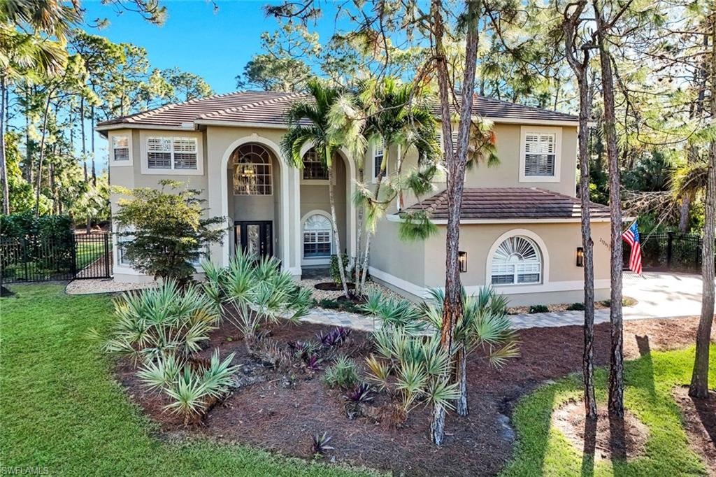 Rare NO-HOA country estate on 1.25 fully fenced acres in highly desirable San Carlos Estates.  Enjoy exceptional privacy, freedom, a peaceful, wooded setting, and an unbeatable in-town location just minutes to Bonita's best beaches, dining, and shopping.  This beautifully renovated two-story home offers approx. 3,900 sq ft of living space, 5 bedrooms, 4 full baths, bonus room with wet bar, custom library, and 2.5 car garage.  A spacious first-floor private suite includes its own living room, bedroom, full bath - ideal for guests or multi-generational living.

The bright open kitchen features custom wood cabinetry, center island, walk-in pantry, and updated Whirlpool stainless appliances. Adjacent laundry room includes storage cabinetry, utility tub, and new Whirlpool pedestal front-load washer and steam dryer.  Sixteen feet of sliding glass doors open to the heated pool and spa with Brand New two-story screen enclosure.  The second-floor primary suite offers two walk-in closets with organizers, illuminated tray ceiling, crown molding, and a romantic private balcony with spiral staircase. Spacious primary bath features a free-standing tub, dual vanities, glass shower, plantations shutters, and beautiful sunset views.  Two additional bedrooms, full bath, library, and large bonus room with wet bar complete the second floor.    Major improvements include:  Two New Trane AC Systems (2025), 80-gal. water heater (2026), 3/4 HP Disposal (2026), Custom LED pool lighting (2026), new Jandy Aqualink Pool Automation with Pentair Intelliflo/Pro3-2 pump, epoxy garage floor, resurfaced pool, and brand-new paver driveway, entry, front porch, and pool deck.  Flood insurance not required.  This home was built high above street level (Finished Floor Elevation at 16.5' NAVD).

San Carlos Estates is a well-established neighborhood known for its large private lots, country-feel setting, and NO HOA fees or restrictions.  Perfect for families seeking space for pets, boats, RVs, or future expansion -- all less than 1 mile to US-41.