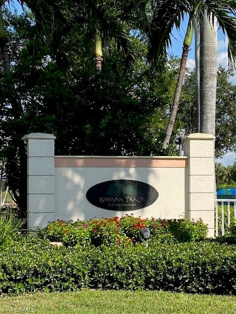 Your perfect Condo retreat awaits at Banyan Trace!  Whether you're looking for a full-time residence, a seasonal getaway, a part-time retreat, or a place to call home forever, this inviting ground-floor condo offers the comfort, convenience, and lifestyle you've been searching for! Enjoy the ease of covered parking just steps from your front door in Banyan Trace, a welcoming and active community featuring a beautiful resort-style pool and separate spa, tennis courts, activity centers and more.  Step through the retractable screened entry door and discover a thoughtfully designed split bedroom floor plan with plenty of space to relax, entertain, and make yourself at home. The guest bedroom and full bath are conveniently located off the main entrance hallway, while the spacious primary suite features a large walk-in closet, additional linen closet, and an ensuite bath with separate vanity area and private shower and water closet.  A wall-mounted TV in the primary bedroom is included for your convenience. The kitchen offers abundant cabinetry, solid-surface Corian countertops, and a new refrigerator and dishwasher.  The adjoining dining area is bright and inviting, with lovely views of the surrounding trees and green space. The living room features a wall-mounted TV and sliding glass doors that open to a  screened lanai overlooking the peaceful greenery.  It's the perfect spot to enjoy your morning coffee, unwind at the end of the day or simply take in the scenic natural surroundings.  Walking paths throughout the community invite you to get outside and enjoy the tranquil setting.  Just off the kitchen and living room, a versatile space offers endless possibilities.  Use it as a den, home office, formal dining area, craft area, or cozy spot to read and relax. Thoughtful extras add even more comfort, including adjustable louvered shutters on all windows and a separate remote controlled Storm Smart roll-down screen on the lanai for wind protection and added shade screening when you want it. Enjoy the best of Southwest Florida living! Banyan Trace is conveniently located near shopping, dining, golf courses, and parks, with easy access to Fort Myers, Gulf Coast beaches, and Southwest Florida International Airport (RSW). Whether you're seeking a peaceful seasonal escape or comfortable place to call home year-round, this condo offers a wonderful combination of convenience, comfort, natural beauty, and resort style amenities.   Come!  Discover your own little slice of paradise at Banyan Trace!
