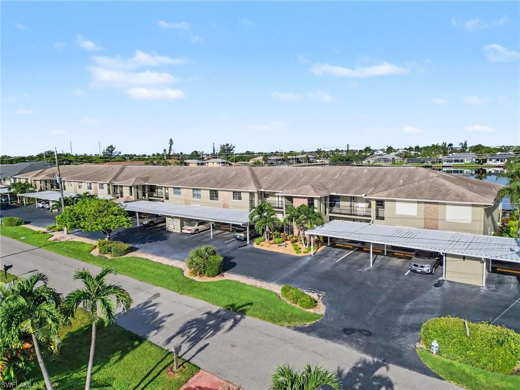 Fantastic first floor, 2 bedroom 2 bath Gulf Access LAKEFRONT condo in the SW Cape. This property boasts nearly 1100sf of living area, great kitchen with solid surface countertops and plenty of cabinets, large living area, spacious master bedroom and guest bedroom, loads of outdoor living space in the screened lanai over looking the lake, so many extras including tile throughout, accordion hurricane shutters, carport, lush landscaping, steps to the community pool and walking distance to Publix. Great location, SUNSET VIEWS, watch manatees and dolphin right in your backyard also close to restaurants and shopping!!