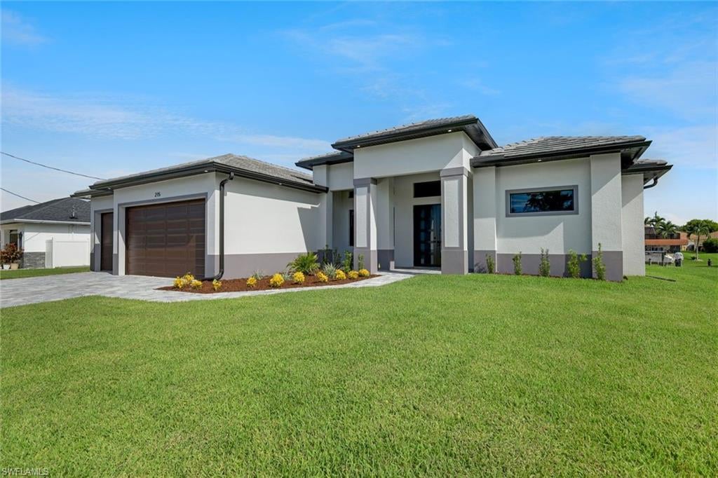 Welcome to the best of Cape Coral luxury waterfront living! Stunning new construction ready for occupancy! Step inside this brand new gulf access home with modern style, sleek lines and a clean color palette; it's your private canvas to create the look and feel you desire. Gleaming, large tile floors throughout, soaring ceilings, 8' interior doors, three-panel sliders and abundant sunlight create a bright, open feel perfect for entertaining and enjoying. The chef's kitchen has a huge Quartz double-waterfall island, stainless steel appliances, glass cooktop, double-wall oven, and adjoining dining area with water views. French doors off the kitchen/living area open to a bright six-window possible fourth bedroom (with closet), or an inspiring office, hobby room, or den. Relax in the large owner's suite featuring a high tray ceiling, floor to ceiling tile feature wall over a deep soaking tub, walk-through dual shower, separate vanities, ample closet space, and enclosed private water closet. The guest wing offers two more bedrooms, a full bath and a full pool bath with direct access to the lanai and connected to the rear guest bedroom creating a second private ensuite living space perfect for visiting guests. Soak up the sun and water views from the huge lanai with an inviting pool and spa and outdoor kitchen ideal for entertaining friends and family. For inclement weather this home’s got you covered with a tile roof and hurricane-rated windows and doors. Your cars and toys will have their place too in the large three-stall garage. Set in a desirable Southwest waterfront community, you won’t find any better locale in Cape Coral for boating, fishing, dining and shopping. And Florida’s famous white-sand beaches are just a short boat or car ride away!