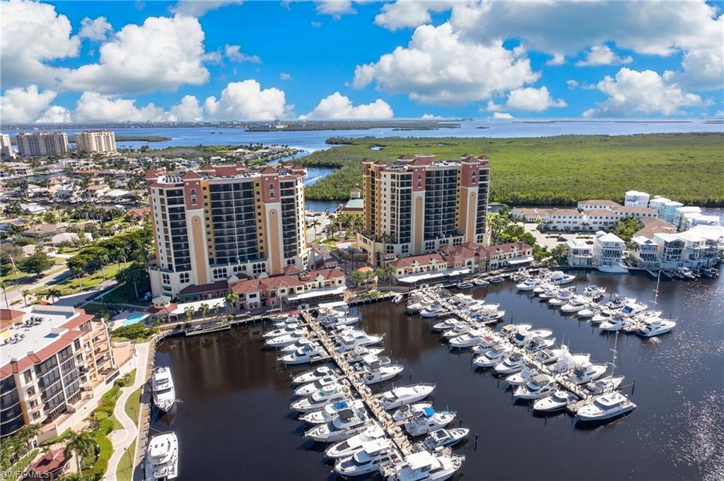 RARE FIFTH-FLOOR RESIDENCE WITH AN EXPANSIVE WRAPAROUND TERRACE adding OVER 400 SQ. FT. OF PRIVATE OUTDOOR LIVING SPACE over other units plus 2 DEEDED GARAGE PARKING SPACES! Experience the ultimate waterfront lifestyle in this beautifully appointed, TURNKEY FURNISHED AND DECORATED luxury condominium overlooking the yacht-filled marina at prestigious Cape Harbour!

What truly sets this exceptional fifth-floor residence apart is its OVERSIZED WRAPAROUND TERRACE, a highly desirable feature not found in the typical residences on other floors. Offering more than 400 square feet of additional private outdoor living space, this spectacular terrace is perfect for entertaining guests, enjoying morning coffee, dining outdoors, or simply relaxing while taking in the outstanding marina views and Southwest Florida’s tropical atmosphere.

Inside, this beautifully furnished residence offers a desirable split-bedroom floor plan that provides privacy and comfort for owners and guests alike. Tastefully decorated and ready for immediate occupancy, everything is in place for you to start enjoying the season from day one. Whether you’re searching for a luxurious winter retreat or a full-time waterfront residence, this condo delivers effortless resort-style living.

TWO DEEDED GARAGE PARKING SPACES provide an additional advantage, offering convenience and value in this sought-after waterfront community.

Step outside your building and discover why Cape Harbour is one of Cape Coral’s premier luxury boating destinations! Stroll along the picturesque marina, admire the impressive yachts, and enjoy some of Cape Coral’s finest waterfront restaurants, boutique shopping, and live entertainment—all just steps from your front door. No need to drive to dinner or entertainment when the best of Cape Harbour is within walking distance!

Residents enjoy an outstanding collection of resort-style amenities, including TWO SWIMMING POOLS, A BEAUTIFUL CLUBHOUSE, TENNIS COURTS, BASKETBALL COURTS, A FITNESS CENTER, and access to the vibrant marina lifestyle that makes Cape Harbour so special.

FIFTH-FLOOR LOCATION. OVER 400 SQ. FT. OF PRIVATE WRAPAROUND TERRACE. TWO DEEDED GARAGE PARKING SPACES. TURNKEY FURNISHED. SPECTACULAR MARINA VIEWS.

This is more than a condominium—it’s an opportunity to enjoy the very best of Southwest Florida waterfront living. Move right in and start living the Cape Harbour lifestyle today!