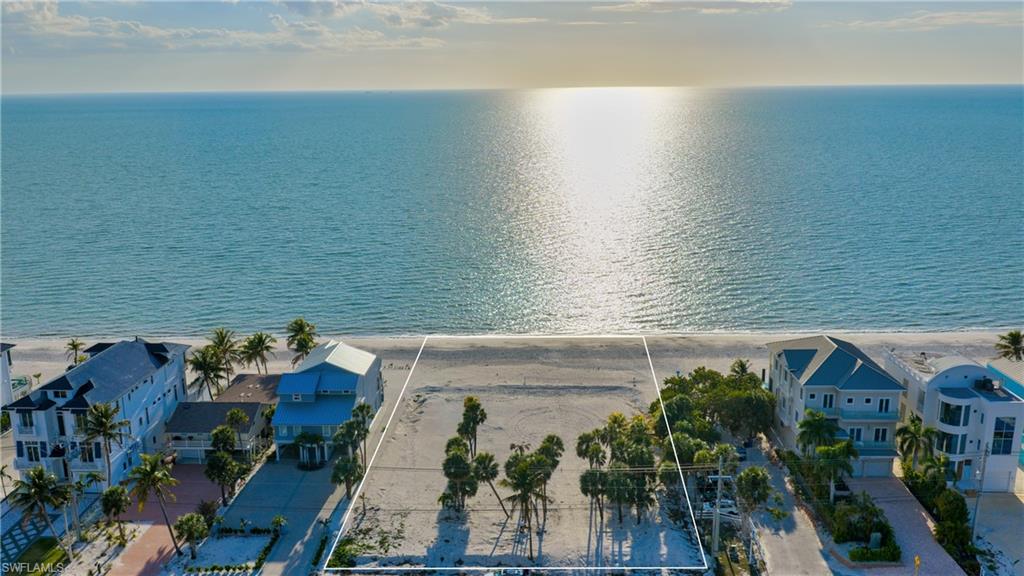 One or more photo(s) has been virtually staged, AI generated or rendered.  NOW AVAILABLE AS A SINGLE LOT PURCHASE. One of three available contiguous beachfront lots to build your beachfront sanctuary on this golden stretch of Bonita Beach.  This prime location offers gorgeous western exposure, iconic sunset views, and white sand beaches for the discerning buyer with the foresight to recognize this incredible opportunity.  The property across the street is a dedicated mangrove preserve . The parcels are available for individual sale or as a double or triple lot combination. New survey of the individual lot as well as the combined real estate are complete. Additional PIDs: 31-47-25-B1-0010F.0210, 31-47-25-B1-0010F.0220