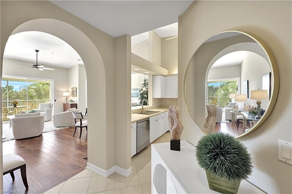 Discover an inviting blend of elegance, comfort and tranquility in this beautifully appointed second-floor residence at Breakwater in Pelican Bay. Offering two bedrooms plus a den and more than 1,600 square feet under air, this pristine condominium features a highly desirable three-car garage, with a conveniently located elevator adjacent to the garage. The thoughtfully designed split-bedroom floor plan provides privacy for owners and guests. A versatile den serves as a comfortable TV room with a sleeper sofa, while a dedicated alcove accommodates a computer desk and printer—ideal for a quick Zoom call or keeping in touch while away from home. The spacious primary suite features dual closets and west-facing views of the Breakwater fountain. An inviting kitchen with a breakfast bar and pass-through counter makes everyday living and entertaining easy, while a generously sized laundry room adds convenience. Freshly painted and lovingly maintained, the residence is ready to enjoy. Walk or bike to the Pelican Bay beach tram and the community’s 20 newly installed pickleball courts. Whole Foods, Publix, Paragon Theater and other shopping and dining destinations are just minutes away. Updated windows, roofs and exterior paint give Breakwater a fresh, beautifully maintained appearance, completing this appealing opportunity to enjoy the Pelican Bay lifestyle.