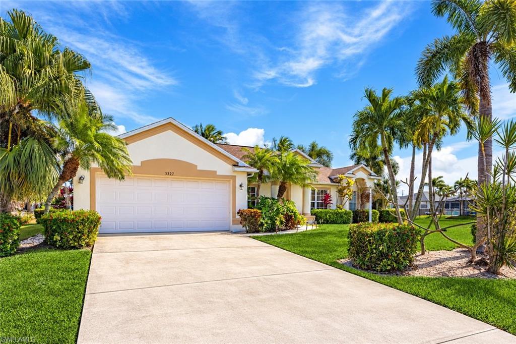 TROPICAL POOL PARADISE IN ONE OF CAPE CORAL'S MOST COVETED NEIGHBORHOODS. Discover this beautifully maintained 4-bedroom, 2-bath single-family home offering an exceptional combination of space, privacy, and the Florida lifestyle! MAJOR 2026 UPGRADES include a BRAND-NEW ROOF, NEW A/C UNIT WITH HURRICANE STRAPS, and an ENTIRELY NEW POOL SYSTEM! Fresh neutral interior paint and new ceramic tile flooring in all bedrooms, the formal dining room, and den/flex space create a refreshed, move-in-ready interior. The spacious, thoughtfully designed floor plan features a formal dining room, eat-in kitchen, and generous den/flex area perfect for a home office, playroom, or additional living space. The kitchen offers stainless steel appliances, abundant cabinetry, a pantry, and convenient breakfast-bar seating. Retreat to the primary suite featuring elegant tray ceilings, a walk-in closet, and French doors opening directly to the pool area. The beautifully appointed en-suite bathroom includes marble flooring, a glass-enclosed tiled shower, soaking tub, dual sinks, and granite vanity. Three additional bedrooms provide comfortable accommodations for family and guests. STEP OUTSIDE INTO YOUR OWN TROPICAL OASIS! Surrounded by gorgeous palm trees, the stunning in-ground pool and expansive paver deck sit within a large screened lanai offering plenty of space for sunbathing, outdoor dining, grilling, and entertaining. Vacant lots directly behind and beside the property provide additional privacy and a peaceful, open setting with fewer neighboring homes. Other highlights include an attached 2-car garage, CITY WATER & SEWER WITH ALL ASSESSMENTS PAID, and a prime SW Cape Coral location offering the perfect balance of tranquility and convenience. With its desirable location, flexible living spaces, extensive updates, and beautiful tropical surroundings, this home offers incredible value at a highly-competitive price. Don't miss your opportunity! Schedule your private showing today!